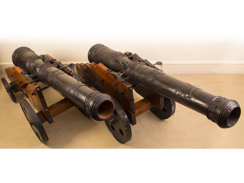 This is an interesting vintage  pair of French bronze cannons dating from the late 20th century. 

The cannons have highly decorative barrels and splendid openwork carriages.

They are suitable to display outdoors as well as indoors. 

Add a little