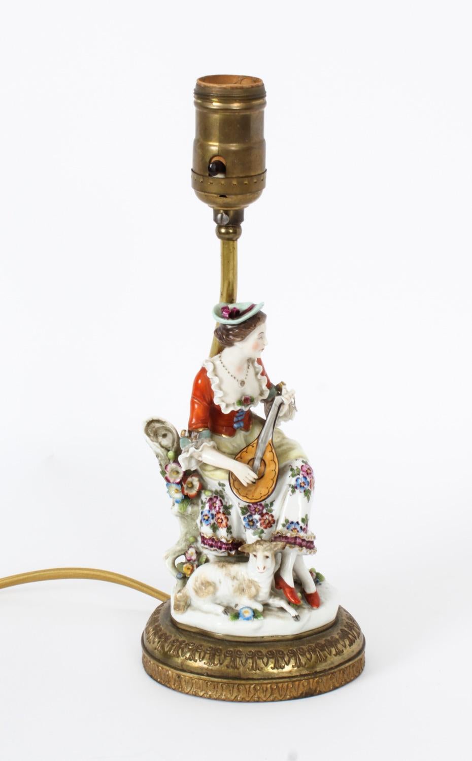 This is a beautiful Vintage pair of Dresden porcelain table lamps, mid 20th century in date.

The figural lamps feature a country lady and gentleman in period costume seated with lambs while playing a mandoline and a flute.

They are a