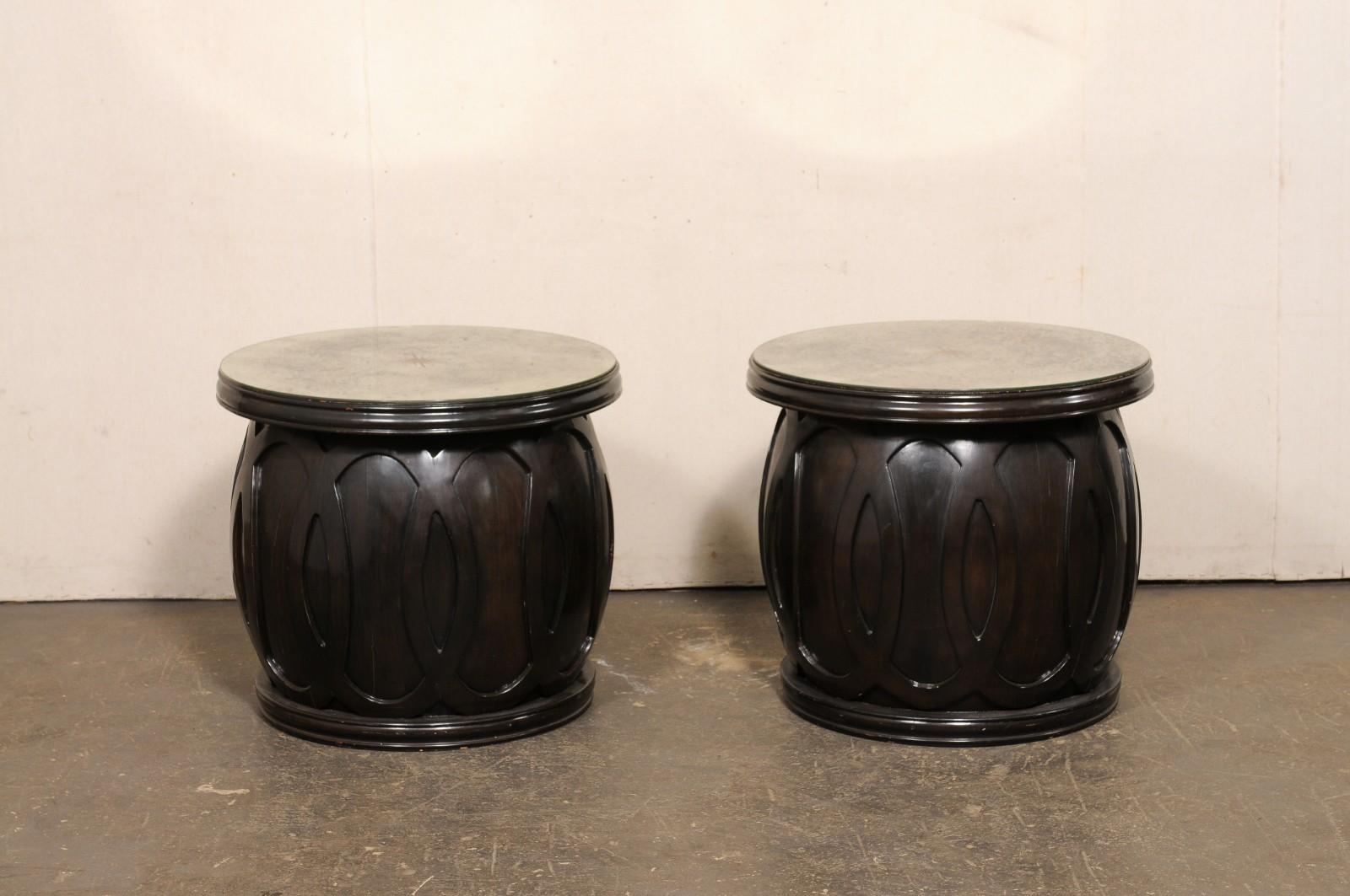 A pair of vintage drum-style wooden side table bases which have been topped with artisan made mirror tops. This pair of side tables feature new artisan made 27.5