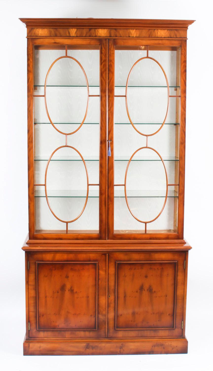 This is a beautiful pair of Vintage yew wood bookcases, dating from the late 20th C.

This magnificent pair of bookcases feature astragal glazed doors in the upper section revealing four glass shelves in each, that can all be adjusted for height.