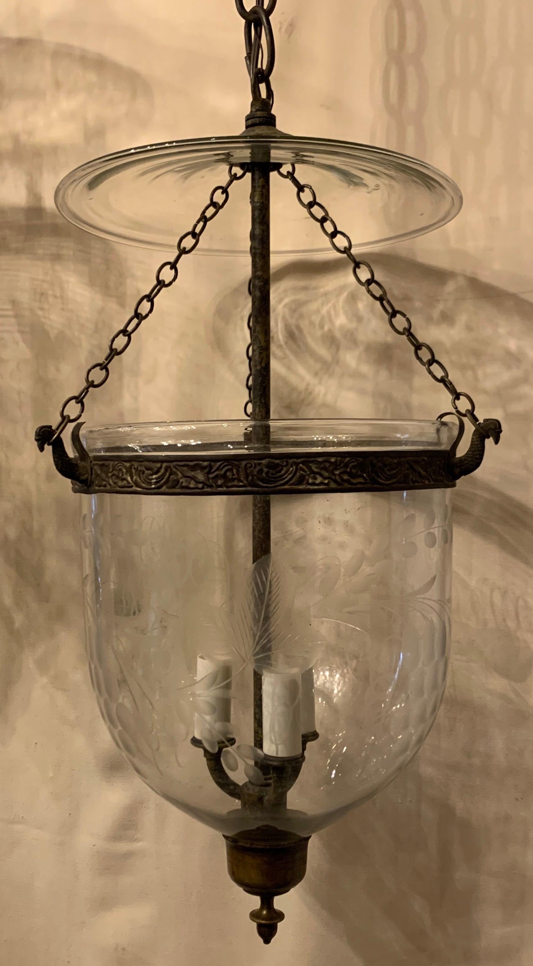 A wonderful pair of etched glass leaves and grapes bell jar lanterns with gilded bronze housing fixtures
Each with 3 newly wired candelabra lights on the interior, accompanied by canopy chain and mounting hardware for installation.
In the manner