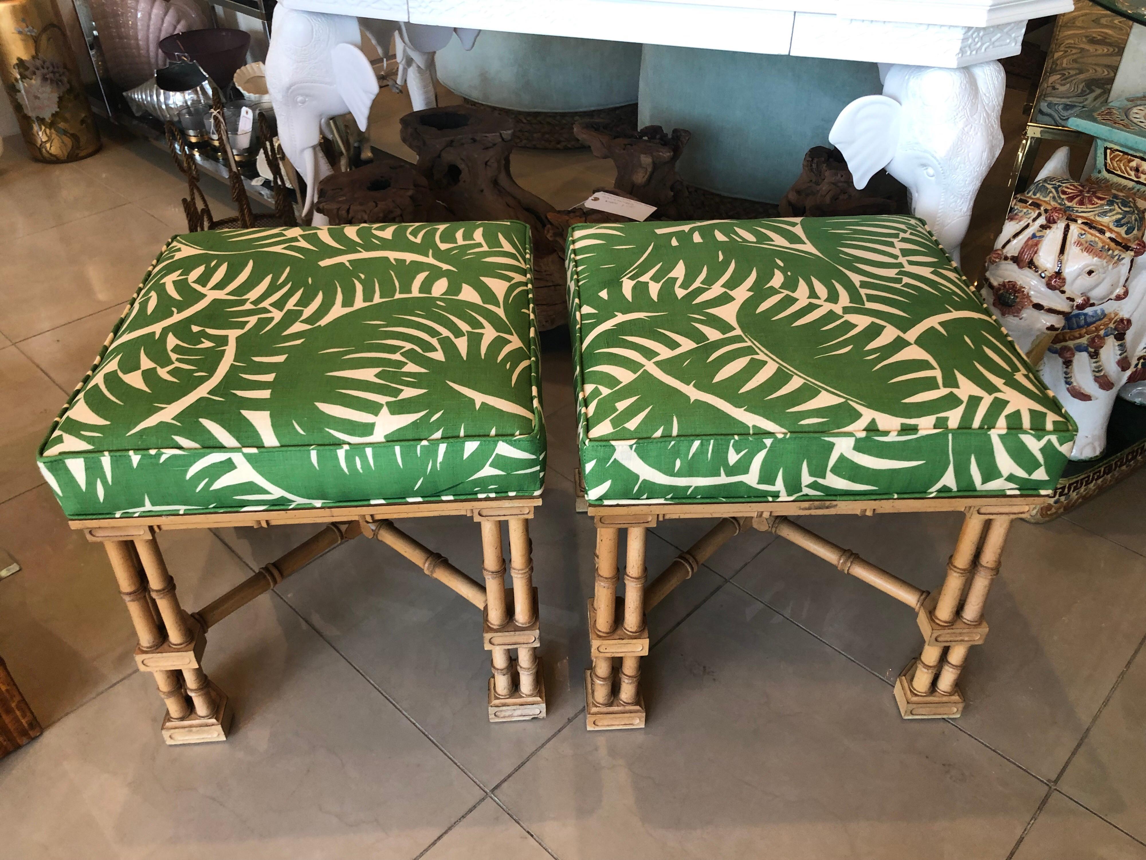 Lovely pair of vintage faux bamboo Ottomans, benches, stools. Newly upholstered in a lovely vintage palm leaf print. All new foam and upholstery. Original wood finish.