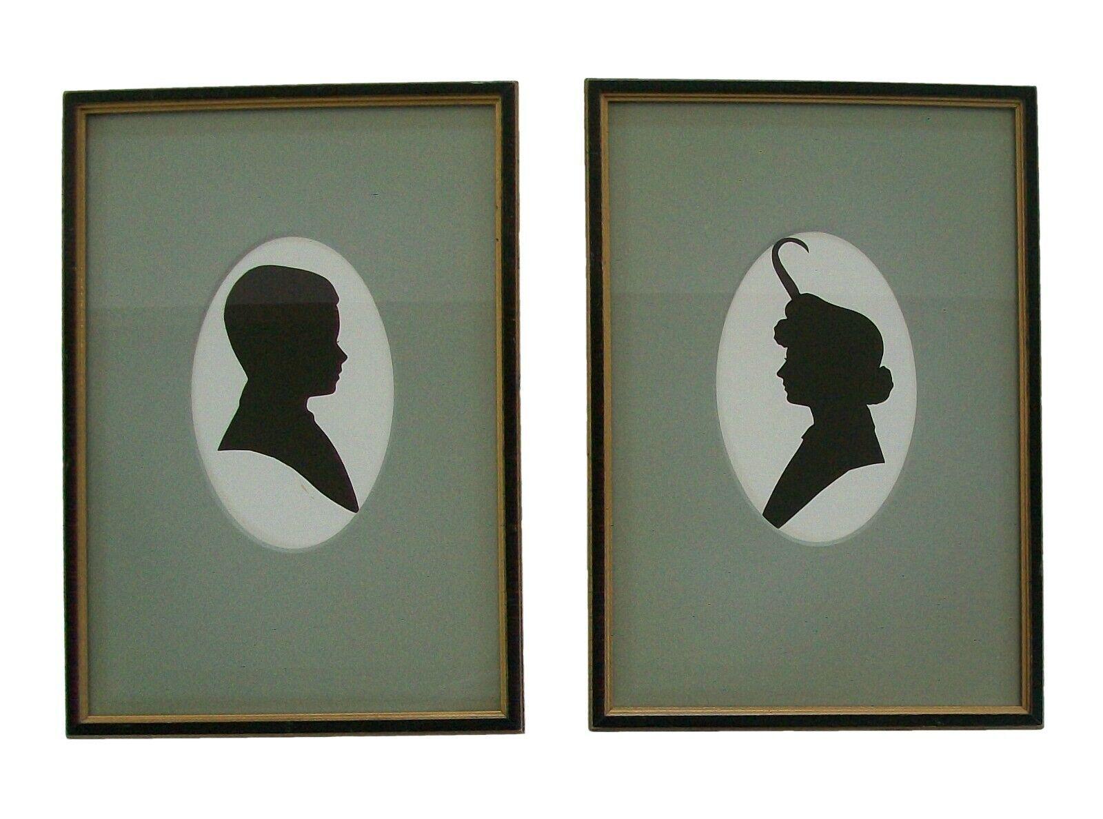 Vintage pair cut paper cameo silhouette portraits - the hand cut portraits glued down to a cream color background - featuring facing profiles of a young man and woman - fine quality vintage gold gilt and black lacquer frames with inset painted
