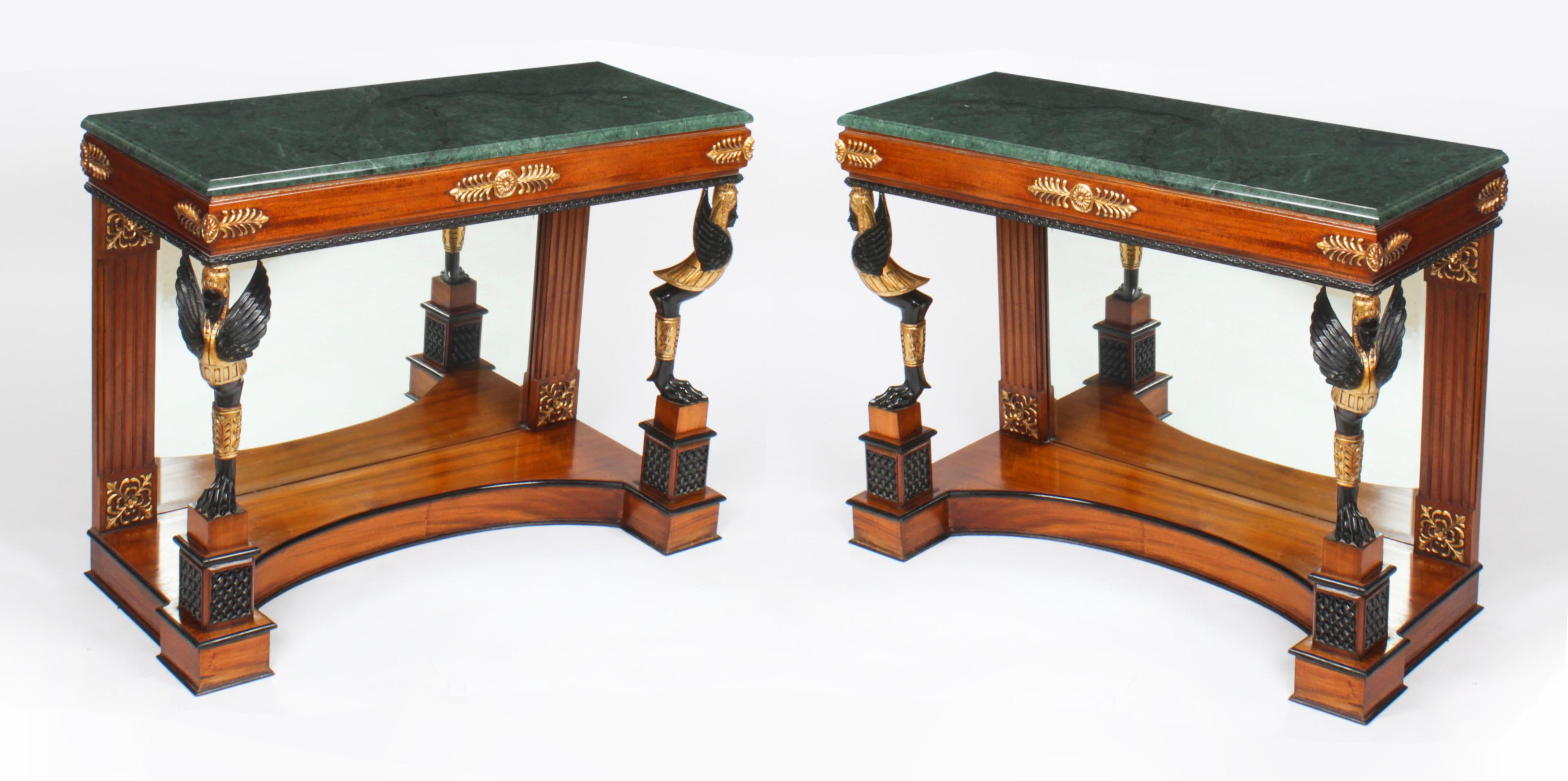 This is a beautiful vintage pair of Empire Revival mahogany gilt and ebonised console tables with striking green Verde Antico marble tops, dating from the last quarter of the 20th Century.

The tables have wonderful decorative winged figural