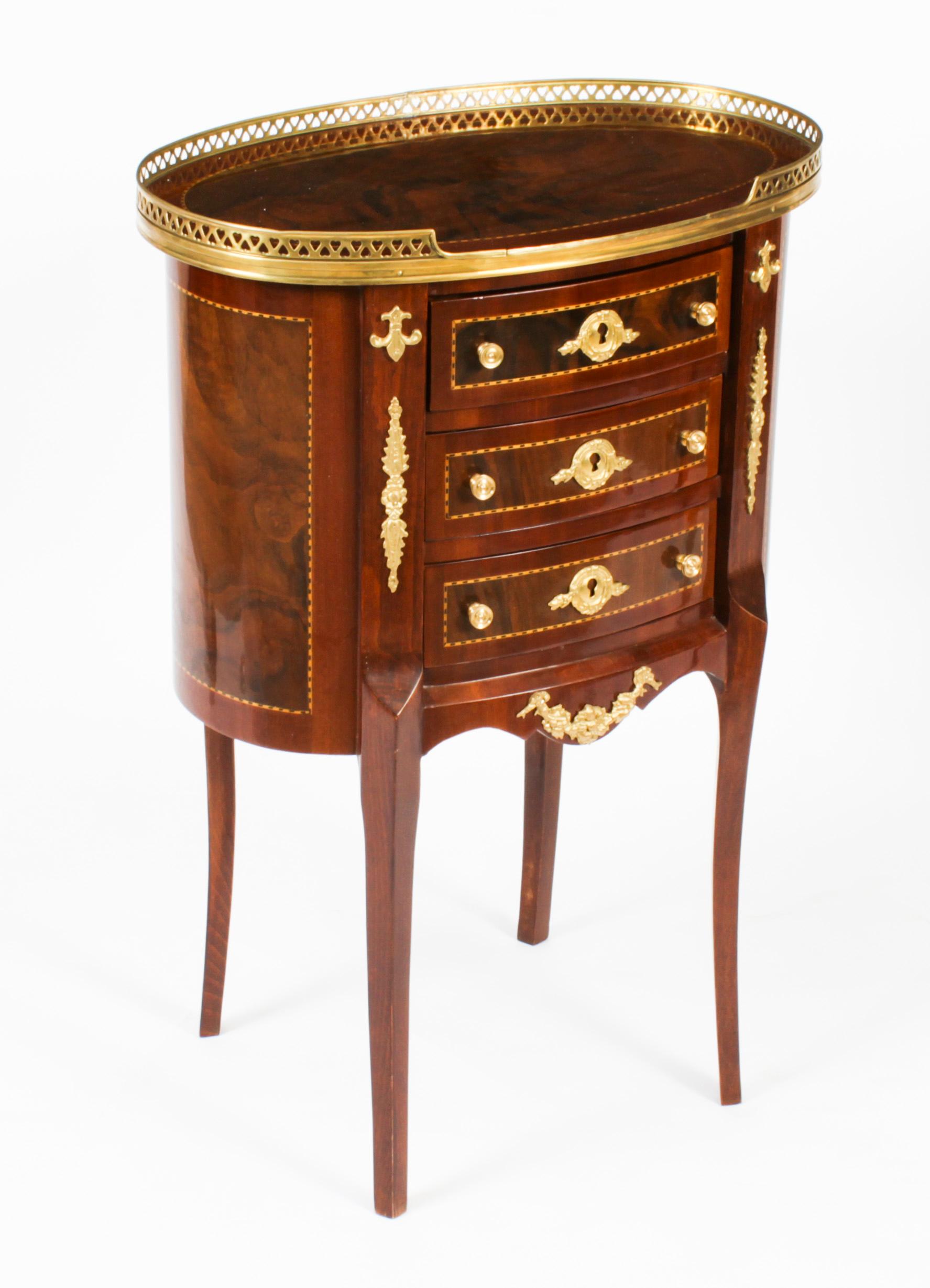 This is a lovely pair of French Louis Revivale walnut bedside cabinets with boxwood inlay, dating from the late 20th century.
 
The three drawer cabinets feature decorative ormolu mounts and handles and are surmouned with a brass three quarter