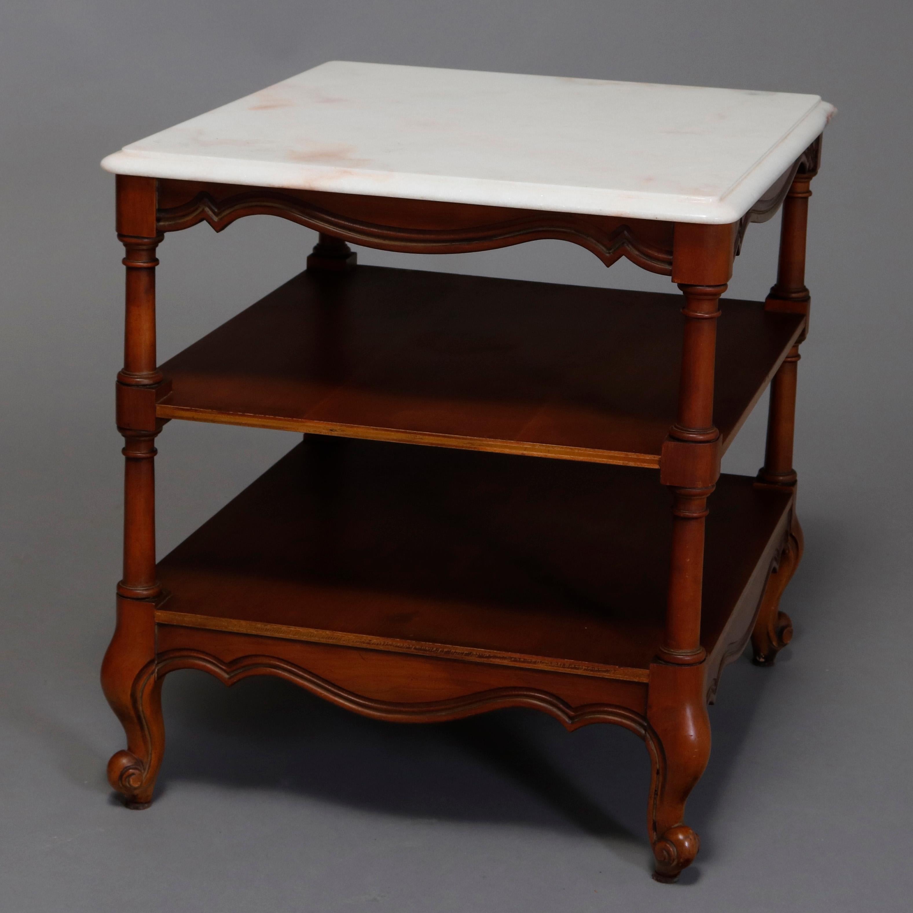 A pair of vintage mahogany end tables each offer beveled marble top surmounting shaped skirt, two display shelves and raised on scroll form feet, 20th century

***DELIVERY NOTICE – Due to COVID-19 we are employing NO-CONTACT PRACTICES in the