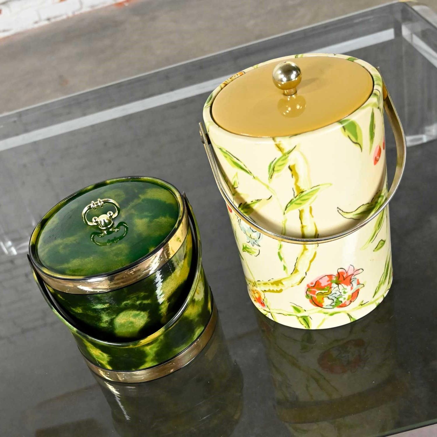 Gorgeous vintage pair of Hollywood Regency ice buckets 1 floral linen-like & vinyl covered fabric bucket & 1 avocado green vinyl bucket with gold trim, both with brass plate knobs. Beautiful condition, keeping in mind that these are vintage and not