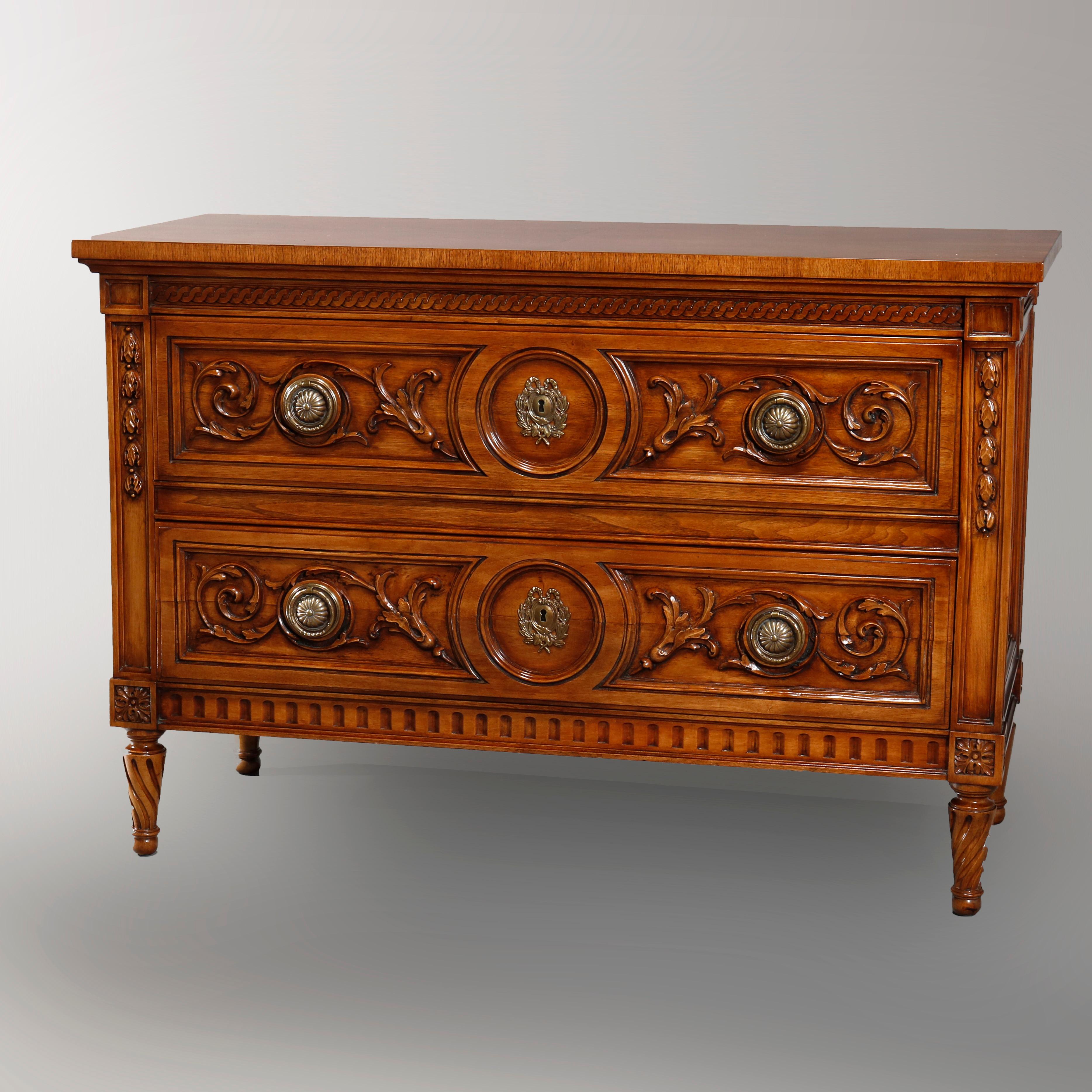 A vintage matching pair of commodes by Karges Furniture offers mahogany construction each with tow long drawers having carved foliate facing flanked by inverted bellflowers and raised on tapered carved rope twist legs, maker label remnant as