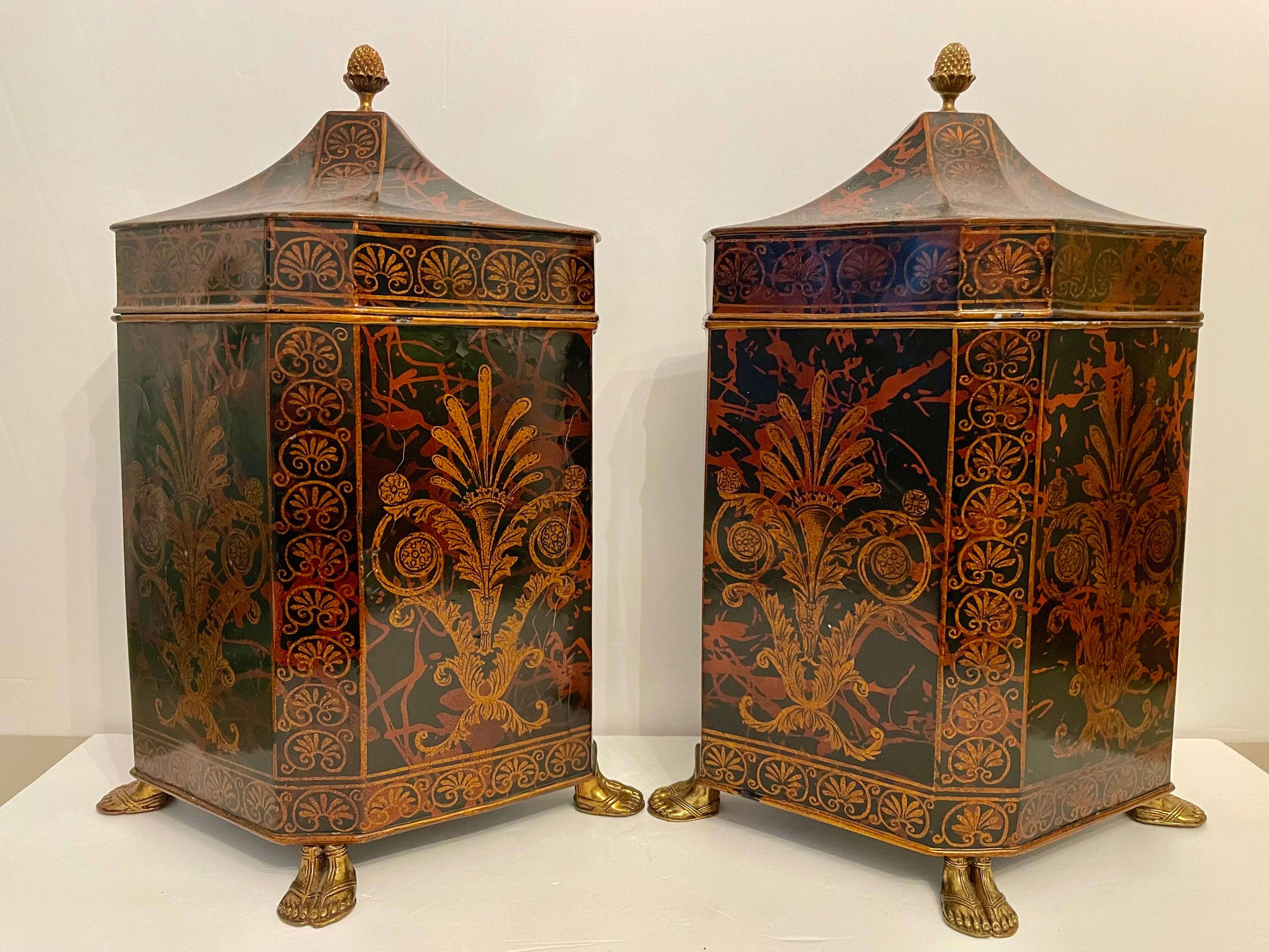 Large pair lacquered Maitland Smith covered canister boxes on brass feet with brass pineapple finial pulls. Regency style. Each measures 12