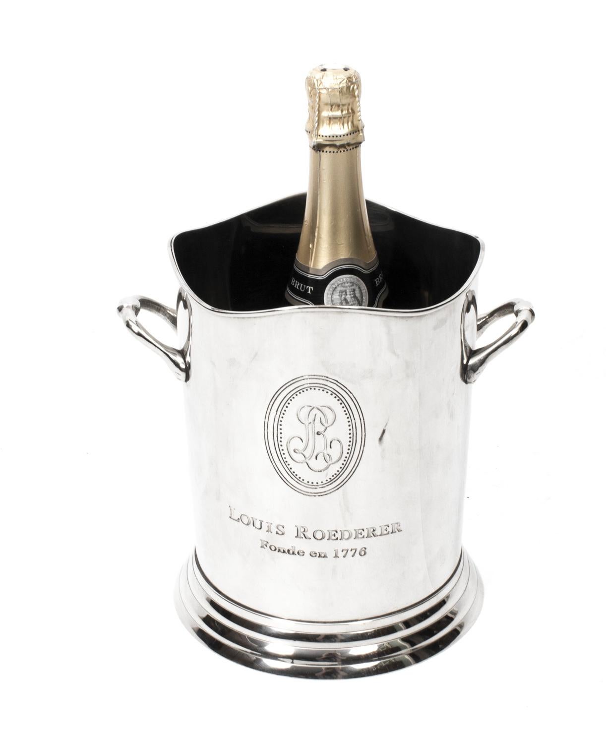 This is a gorgeous vintage pair of silver plated champagne / wine coolers. 

They are each boldly engraved Louis Roederer Fonde en 1776 on the sides with the LR logo.

Each cooler has twin carrying handles and the lip of each is decoratively