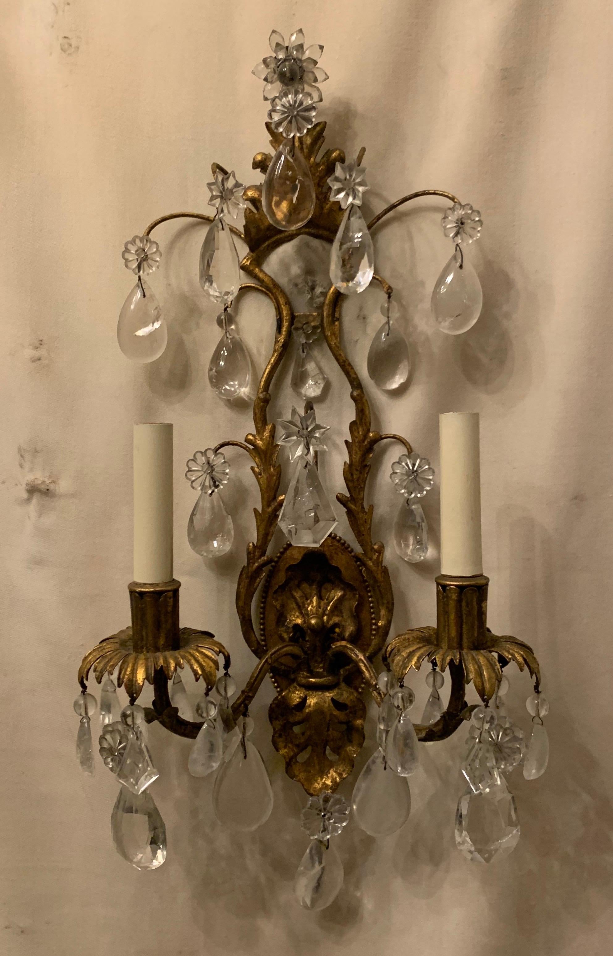 A wonderful vintage pair of Maison Baguès rock crystal and gold gilt tole filigree two candelabra light sconces.