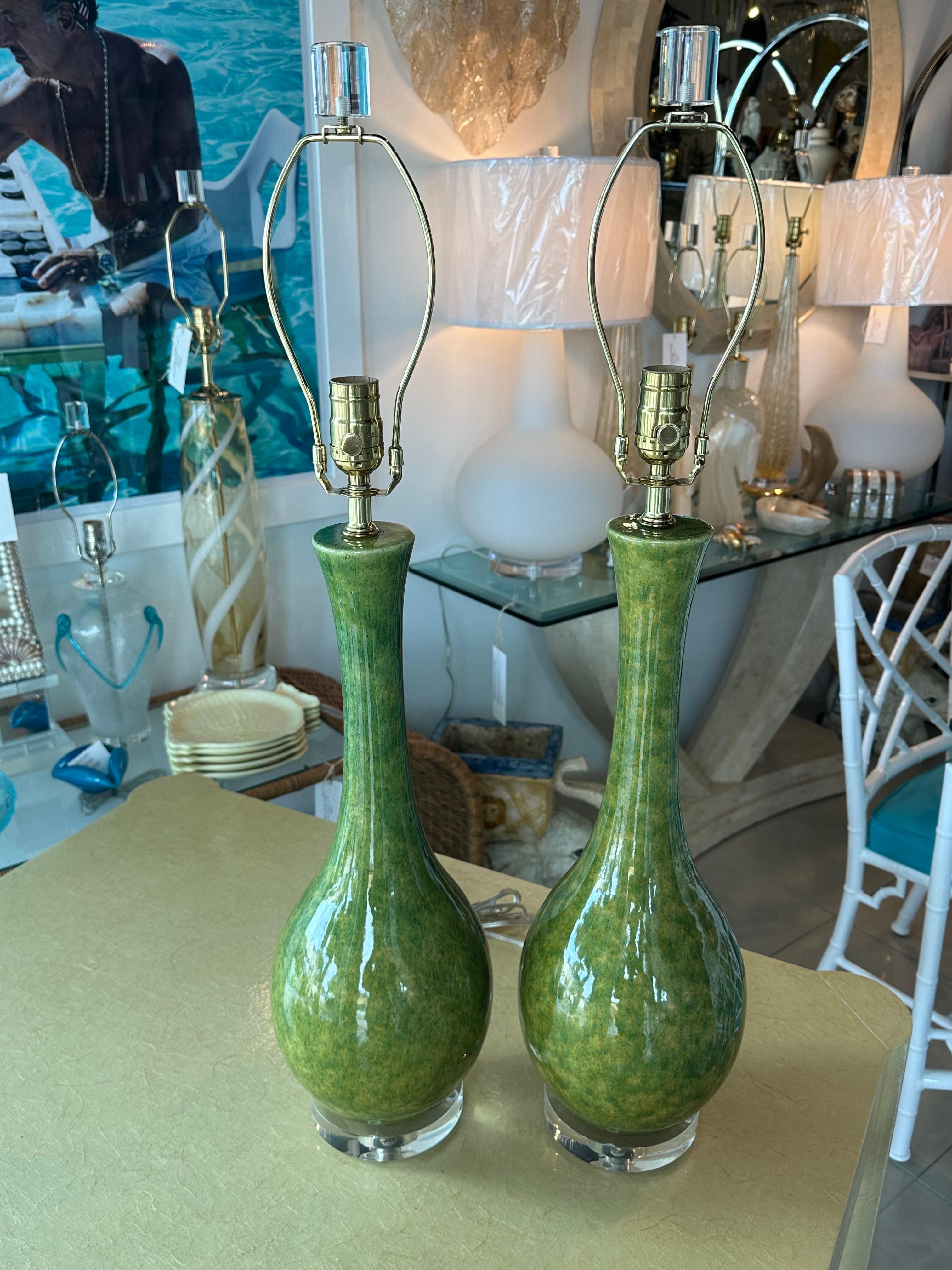 Wonderful vintage pair of Mid-Century Modern ceramic glazed table lamps. Variations of Green with some yellow. Newly wired with all new brass hardware, 3 way sockets, clear cord. Lucite bases and matching lucite finials. No chips or breaks.