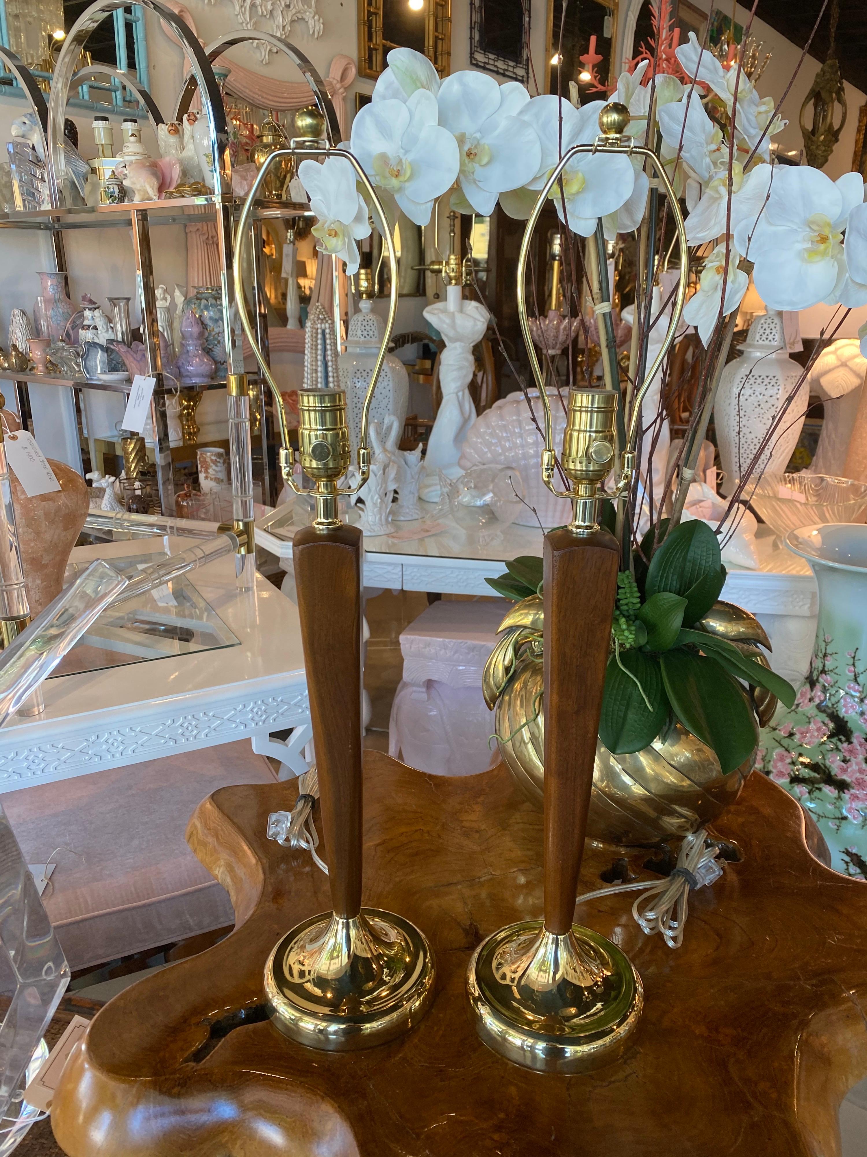 Lovely pair of vintage Mid-Century Modern Danish table lamps. Brass and wood. These have been restored to perfection! The original brass base has been newly plated, all new matching brass hardware and 3 way socket, newly wired. 
Height to finial is