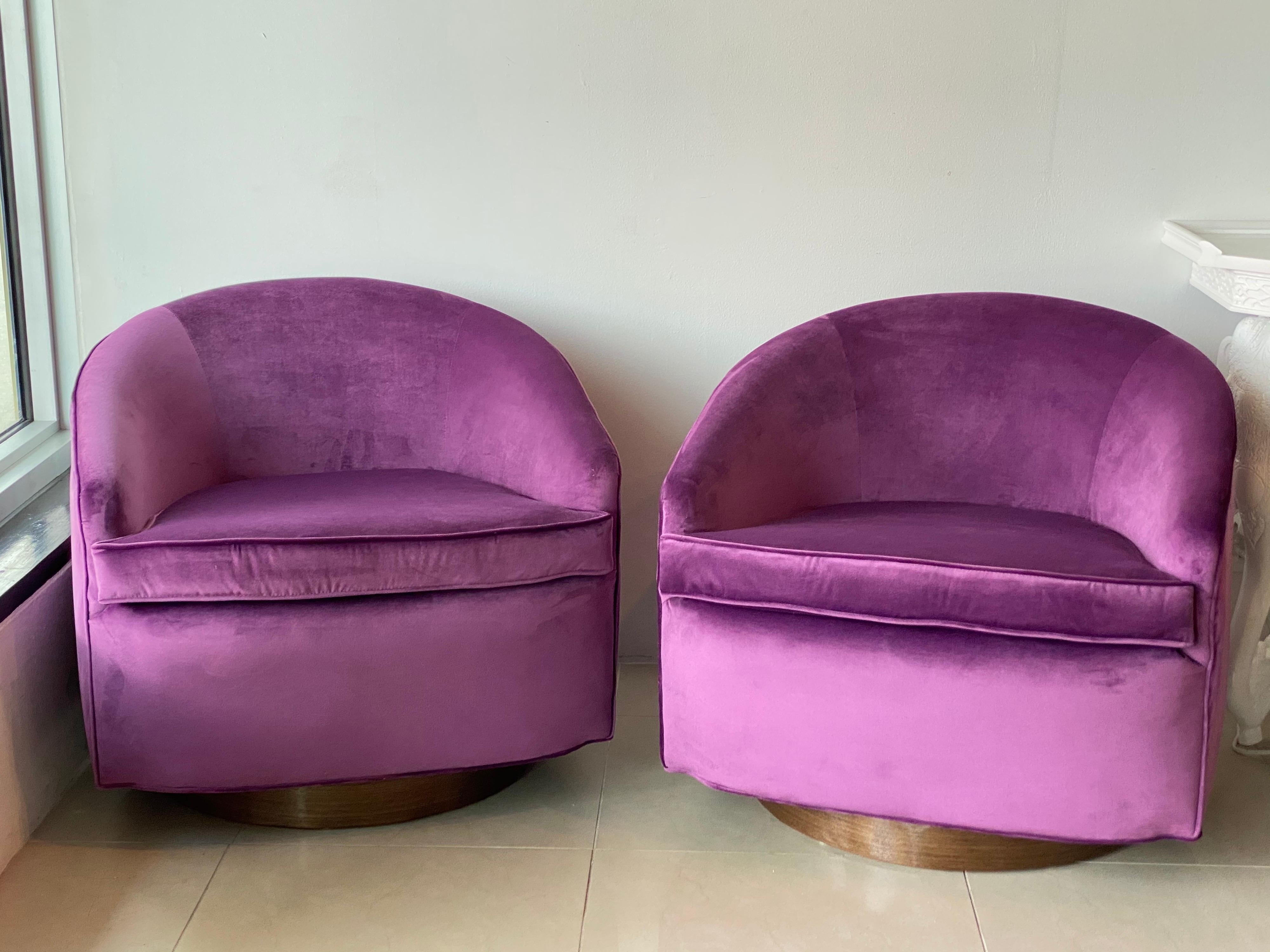 Vintage pair of Milo Baughman style swivel barrel chairs. These have been completely restored. All new foam and insides, newly upholstered in a rich eggplant velvet. Restored walnut bases. If you would like an additional shipping quote please let me