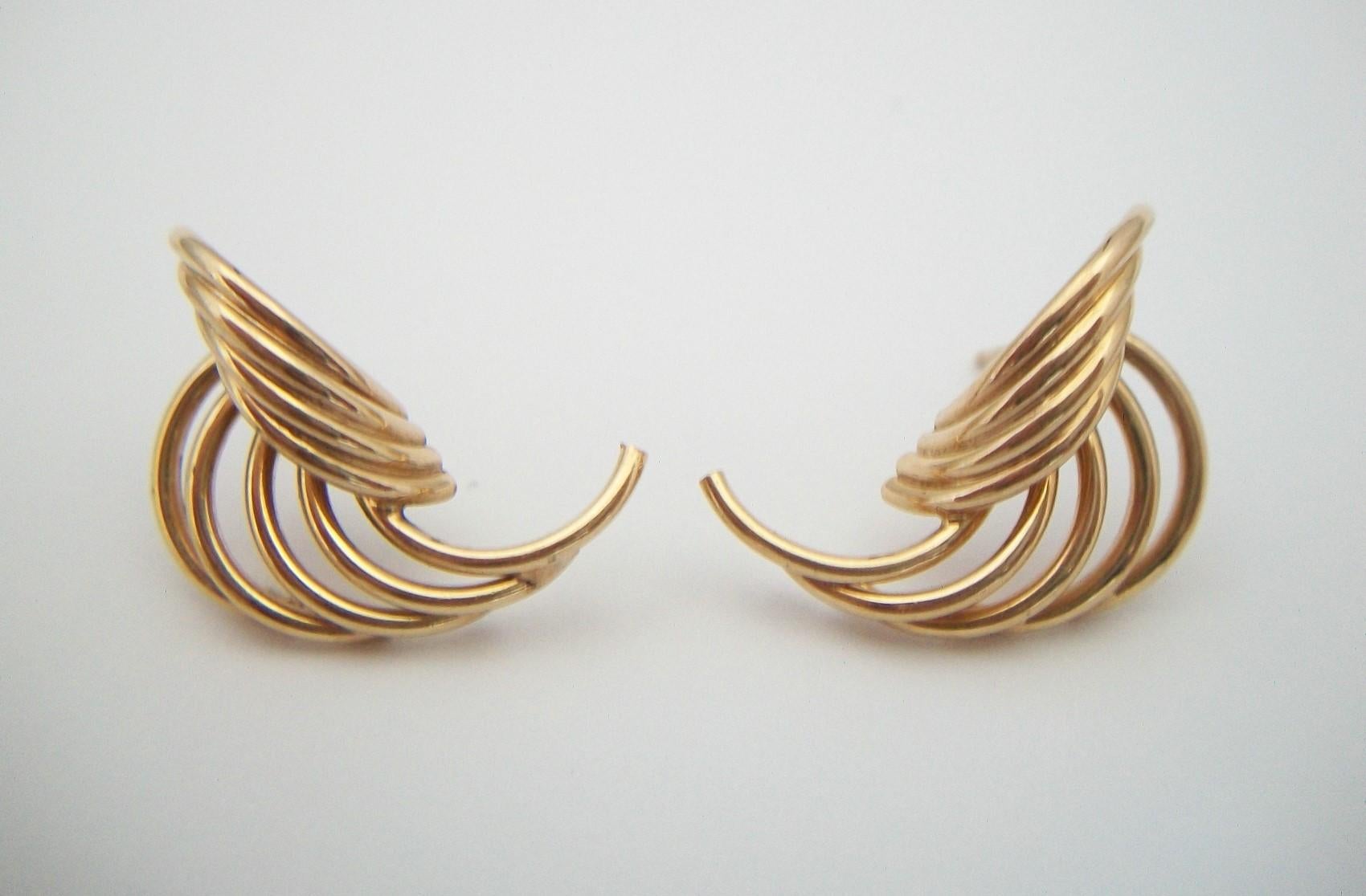 Vintage pair of Retro style 10K yellow gold earrings - featuring a 'C' scroll wirework design - butterfly backs (gold tone - not photographed) - signed on each post (unidentified maker - see last photos) - United States - circa 1990's.

Excellent