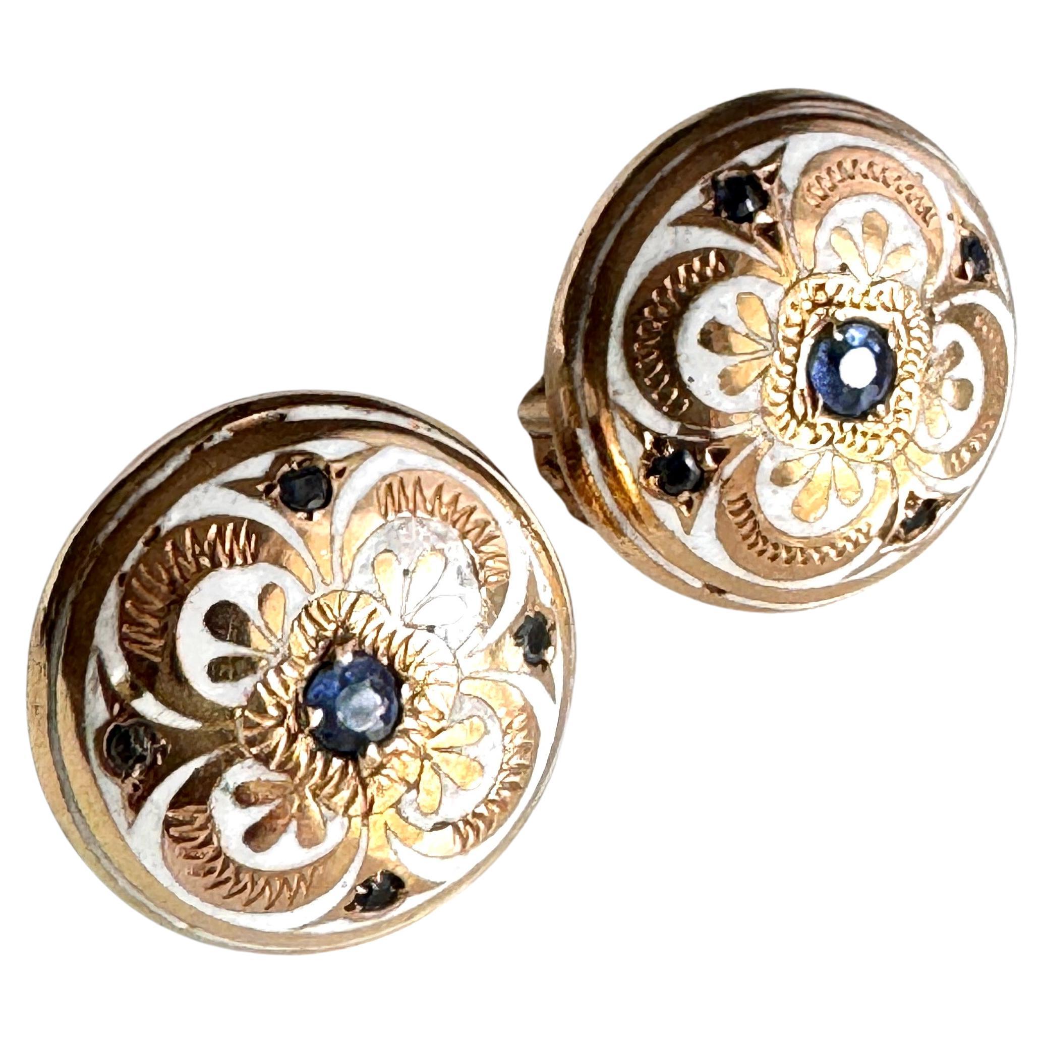 Vintage Pair of 14K Gold Enamel Clip On Earrings
Handmade in 14kg each earring decorated with white enamel and 4 blue tine sapphire and larger in the center. The earrings are hollow inside and not heavy to wear. About 0.75 diameter and 9.5 grams.