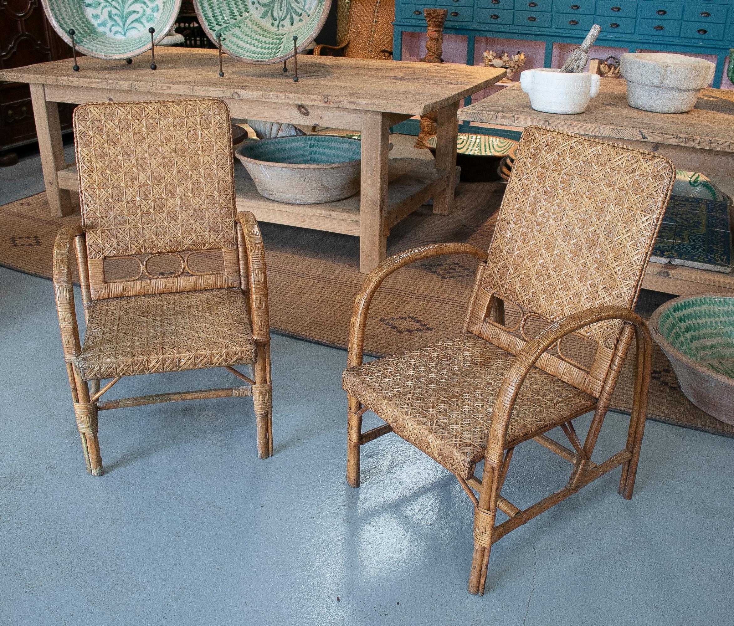 Vintage pair of 1950s Spanish hand woven wicker on wood armchairs.