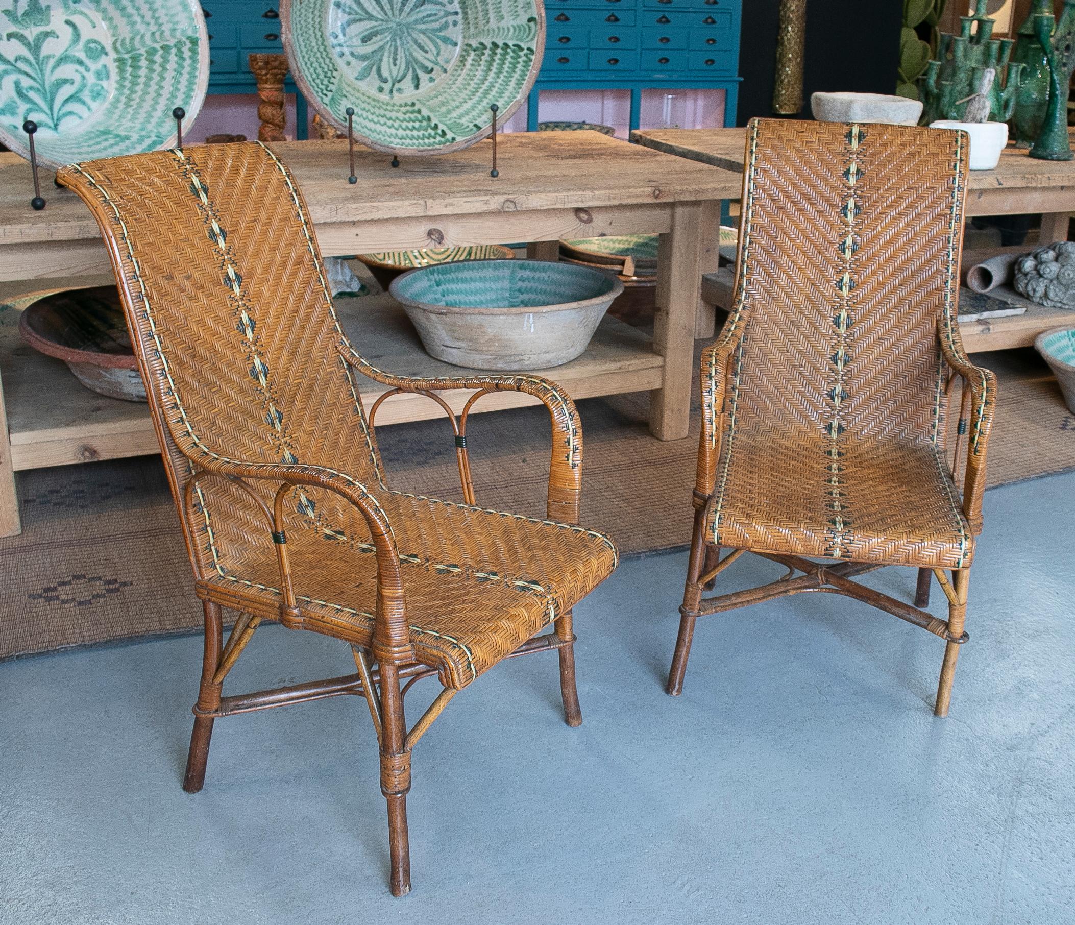 Vintage pair of 1950s Spanish hand woven wicker on wood armchairs.