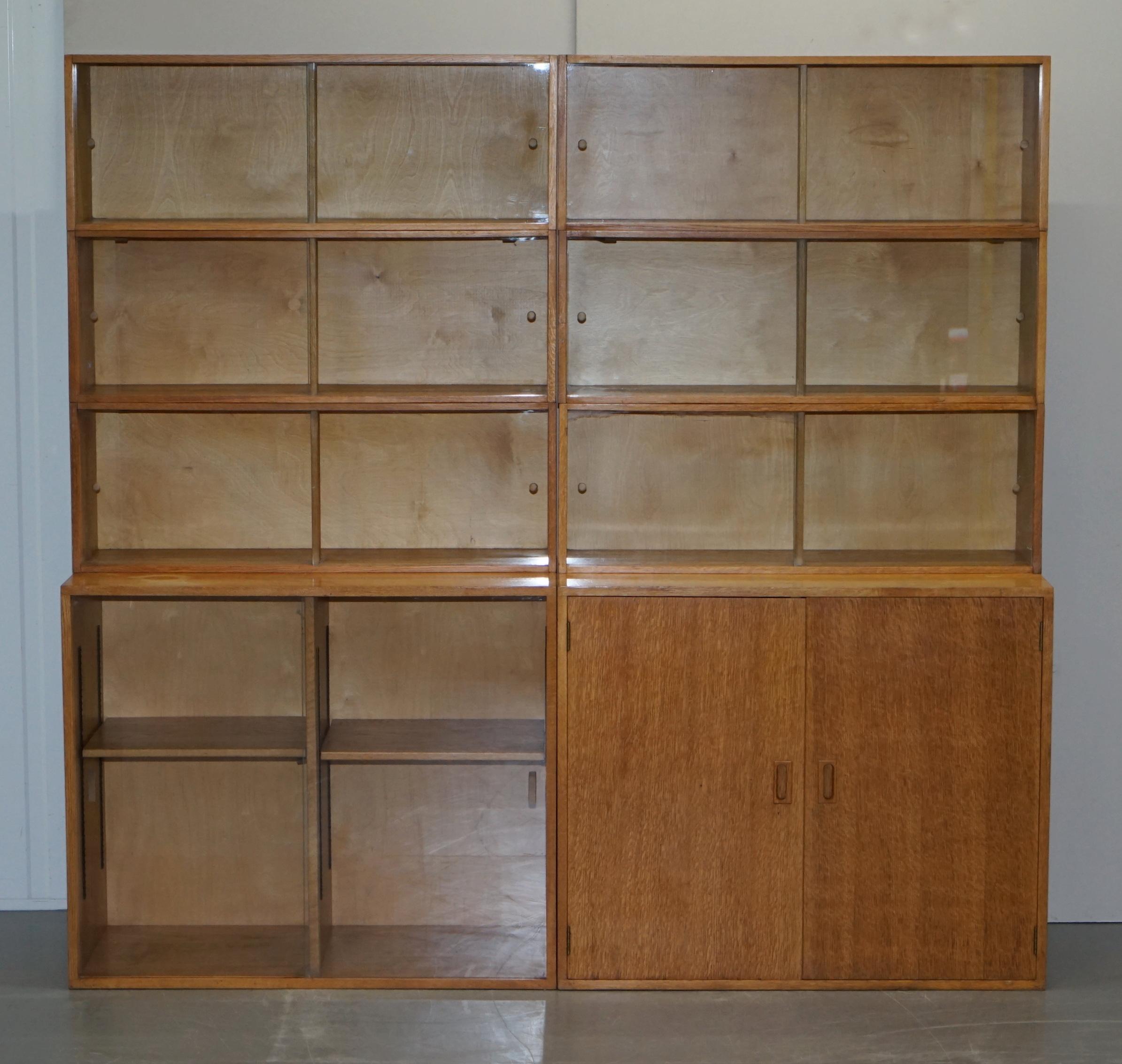 We are delighted to offer for sale this pair of 1972 dated “Phoenix Bookcases” legal library modular stacking bookcases in oak with glass sliding doors

A very good looking well made pair of traditional English legal bookcases. These are modular