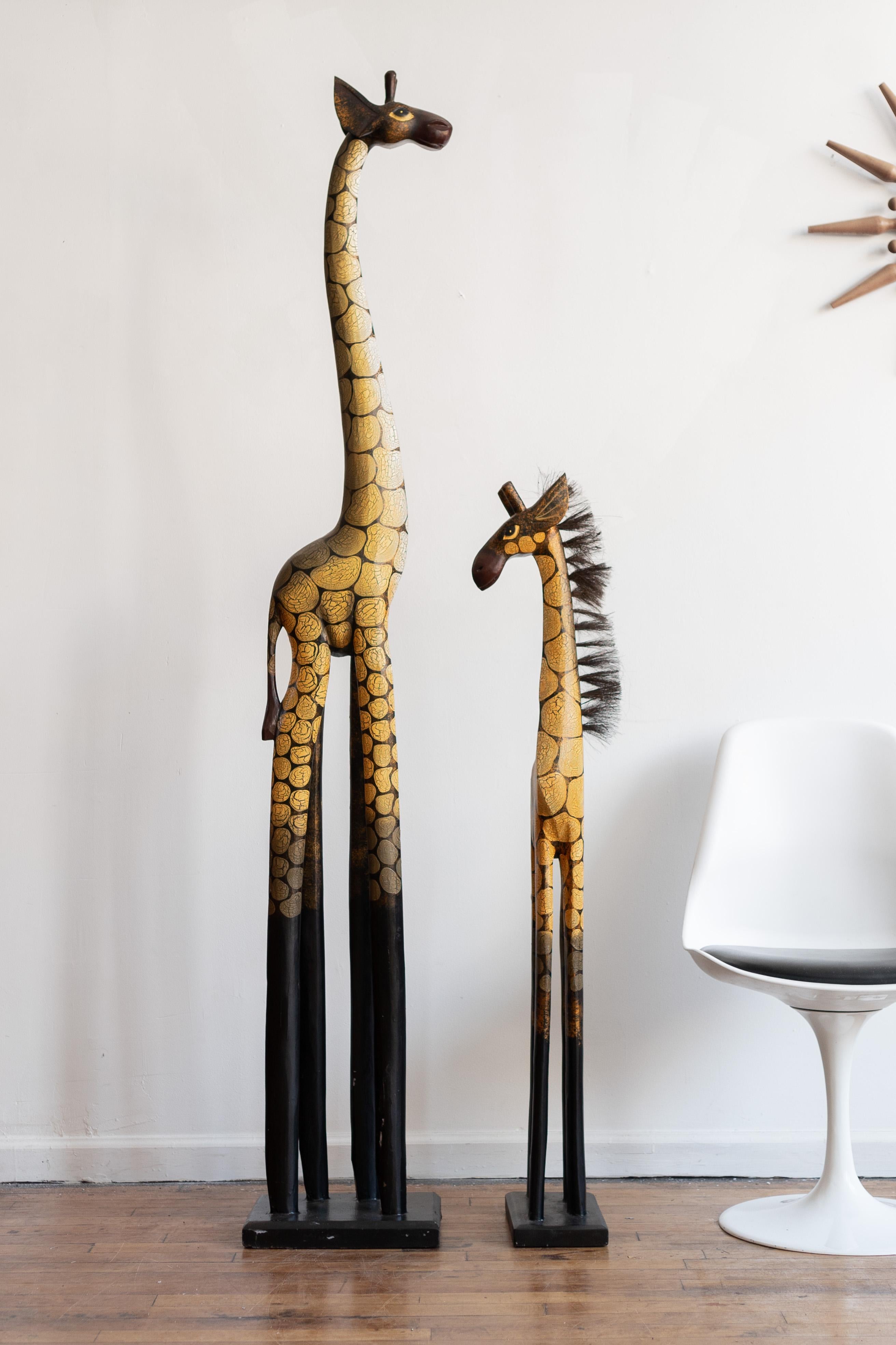 Large giraffe: 24.5” x 16.5” x 74”H

This is a pair of large and striking hand-carved giraffe figurines. At a little over 6' tall, the mom brings serious drama, while the baby giraffe's fierce expression and bristled mane brings all the charm. The