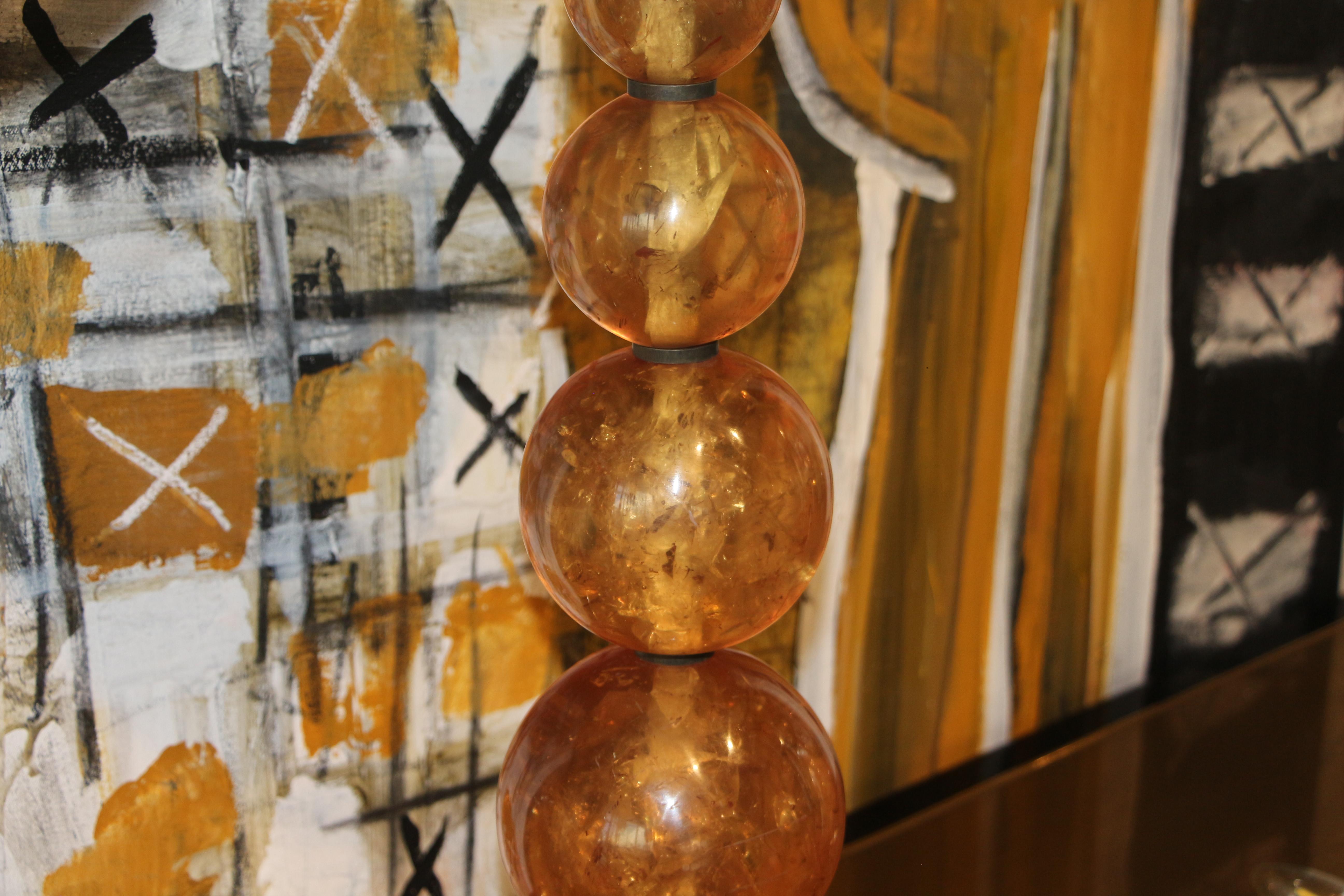 A nice vintage pair of stacked spherical fractured resin lamps. they have matching finials. They bear a label that reads Renaissance 2000 Dallas, Texas. I know the word has an extra n but that is how it's spelled. In working condition. These lamps