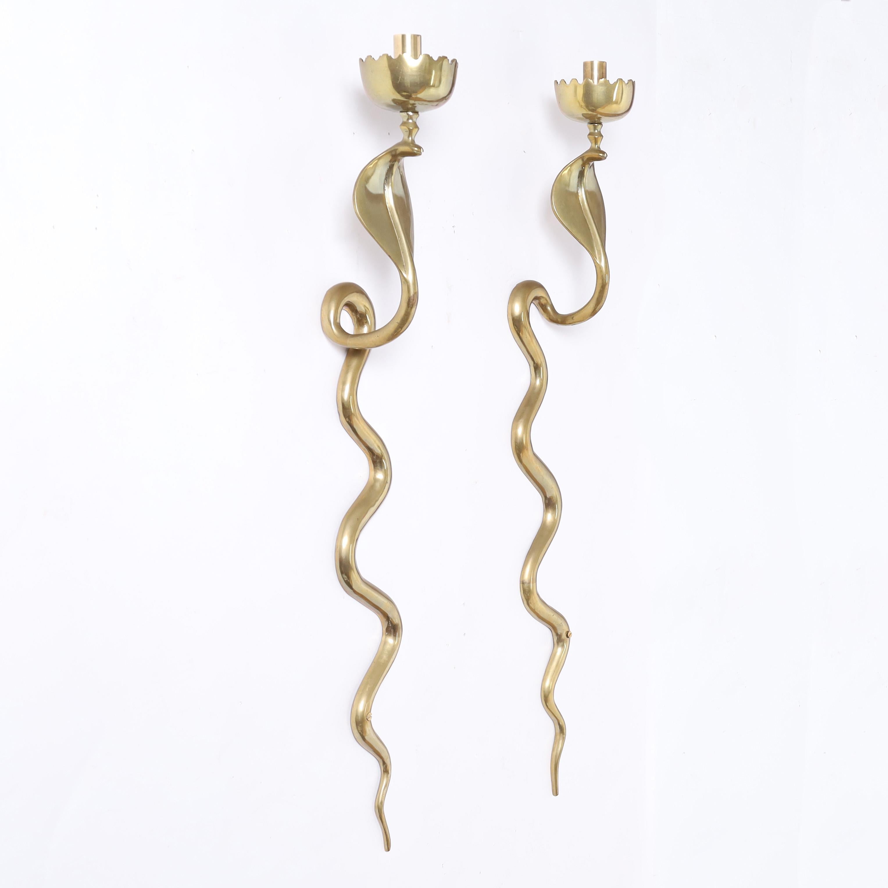 Striking pair of mid century Anglo Indian polished brass cobra or snake wall sconces. 