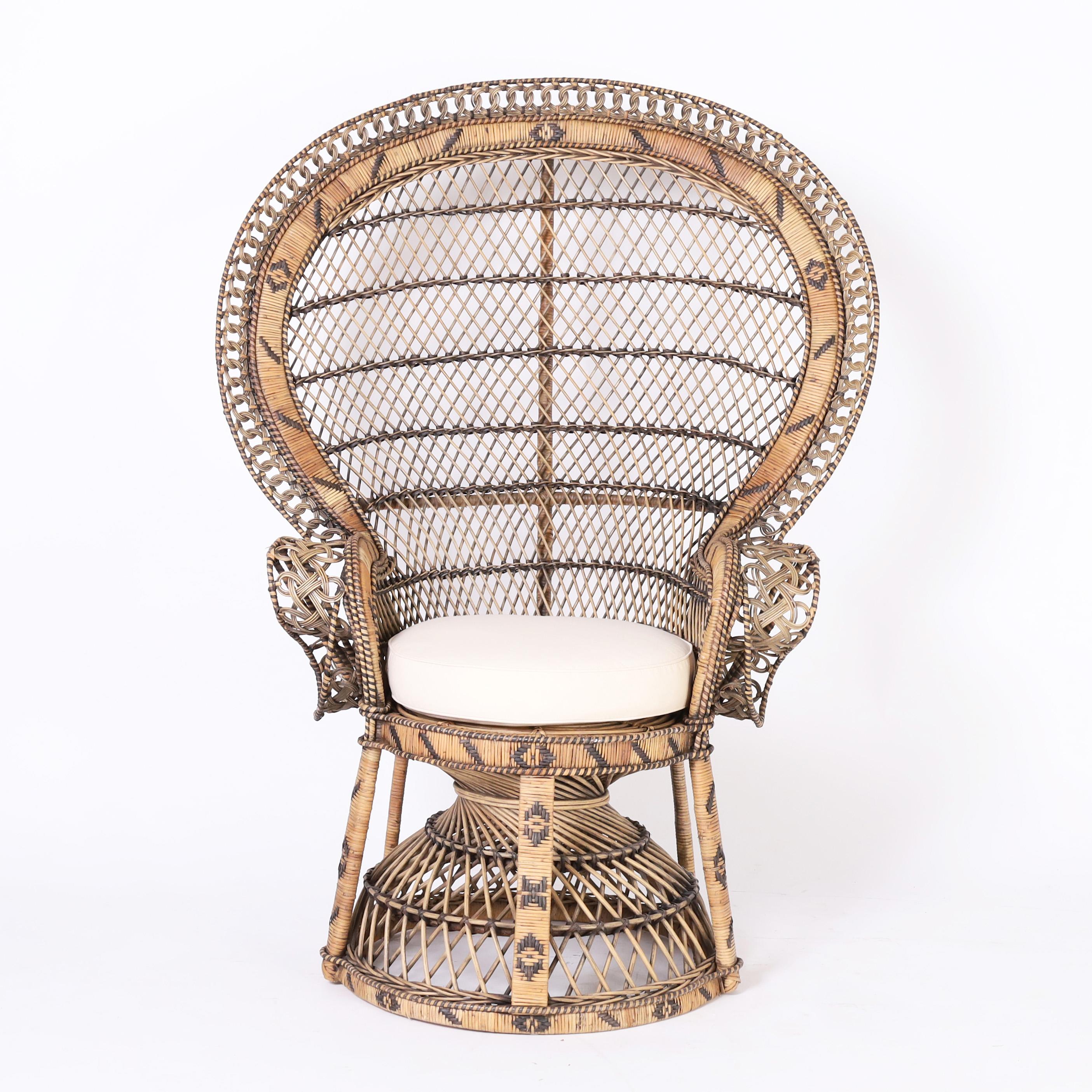 Impressive pair of Anglo Indian peacock chairs, ambitiously handcrafted in wicker and rattan in classic style and decorated with painted rattan in geometric designs. 