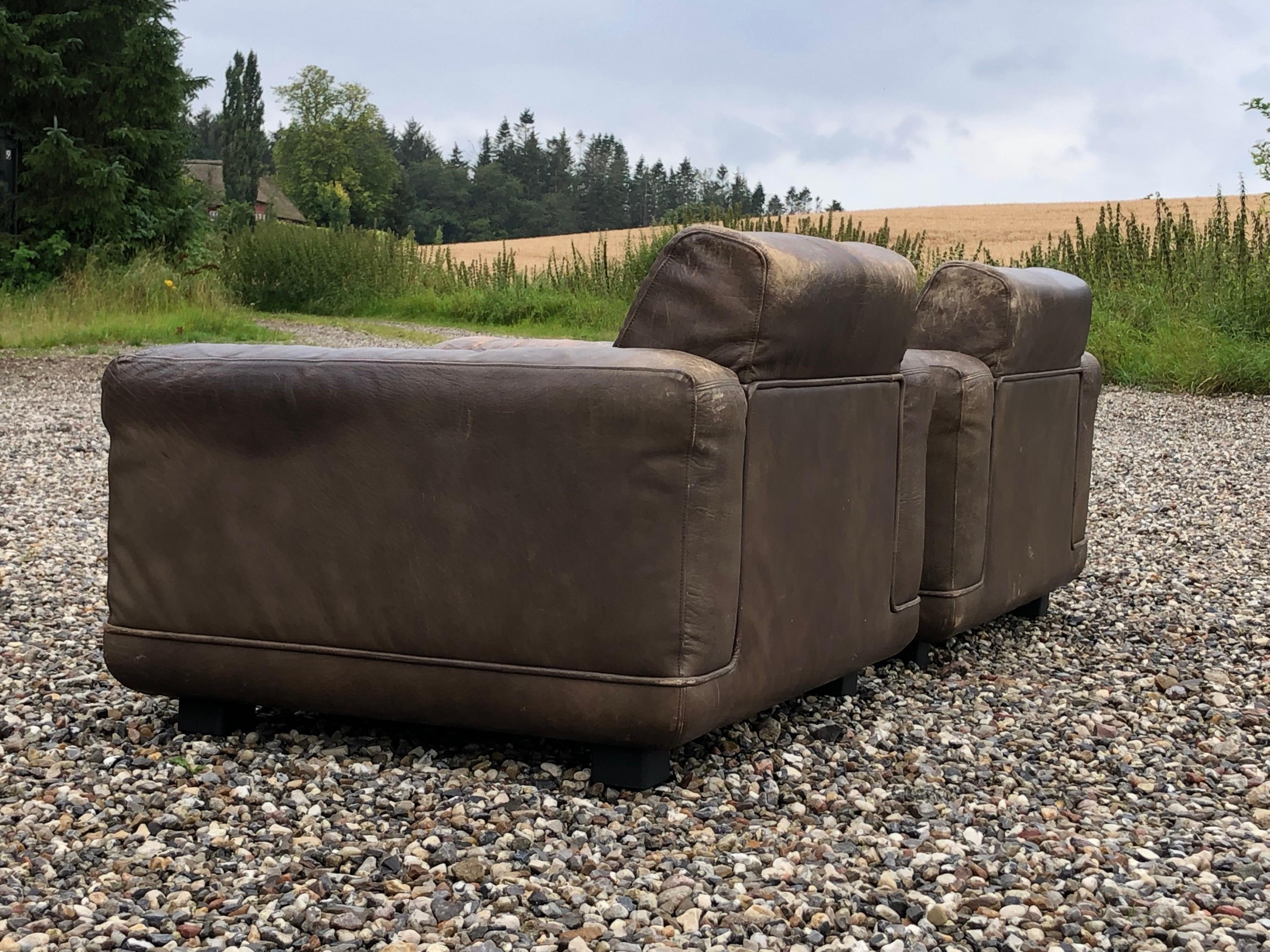 A matching pair of 1970ties large and very comfortable armchairs in Brown leather. They have rich patina. They are designet by danish architects Søren Nissen & Ebbe Gehl. 