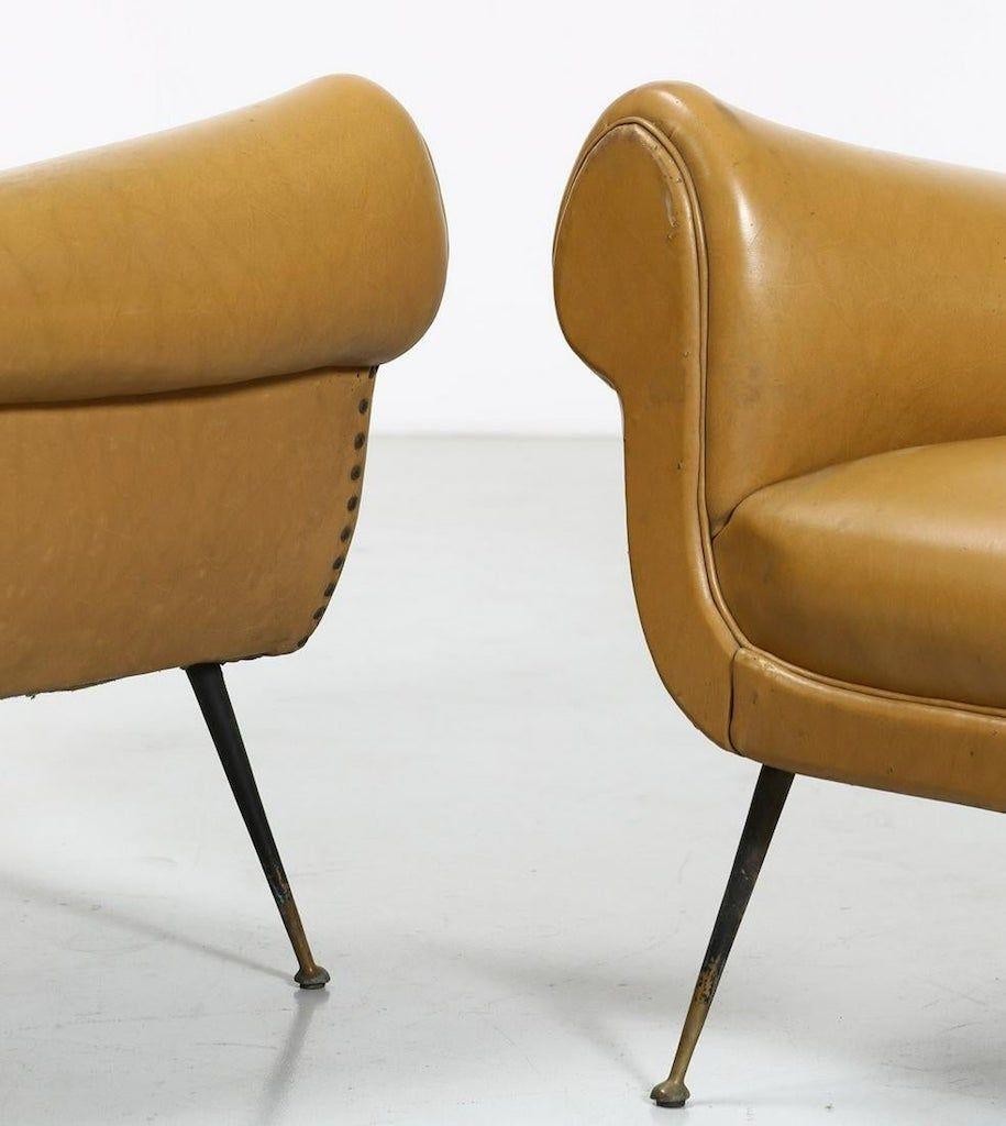 Vintage pair of armchairs is an original piece of design furniture designed by Gigi Radice in the 1950s.

Made of brass, painted metal and padded vinyl leather.

Each armchair has an iron and brass legs.

In very good conditions.

This