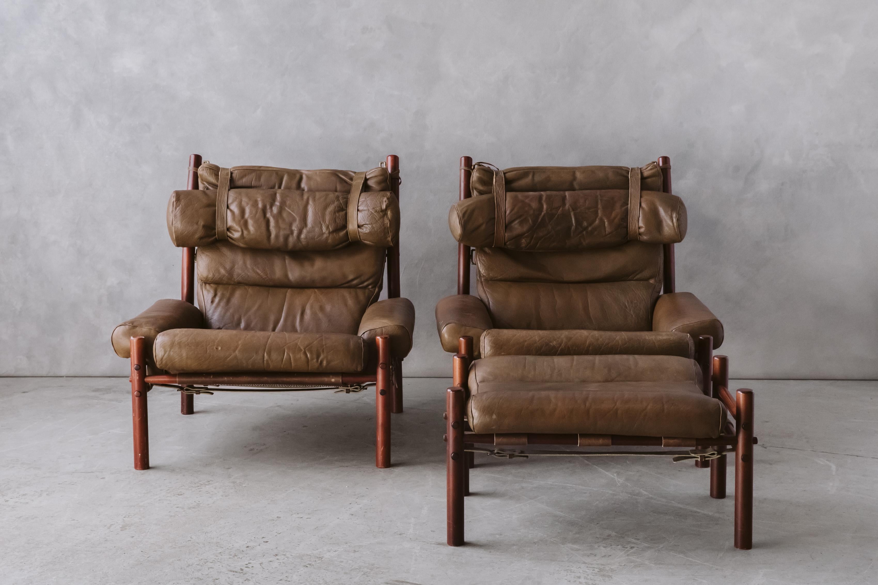 Vintage Pair Of Arne Norell Lounge Chairs, Model Inca, circa 1970. Original brown leather upholstery on a stained birch frame. Nice wear and patina. Includes one ottoman.

We prefer to speak directly with our clients. So, If you have any questions