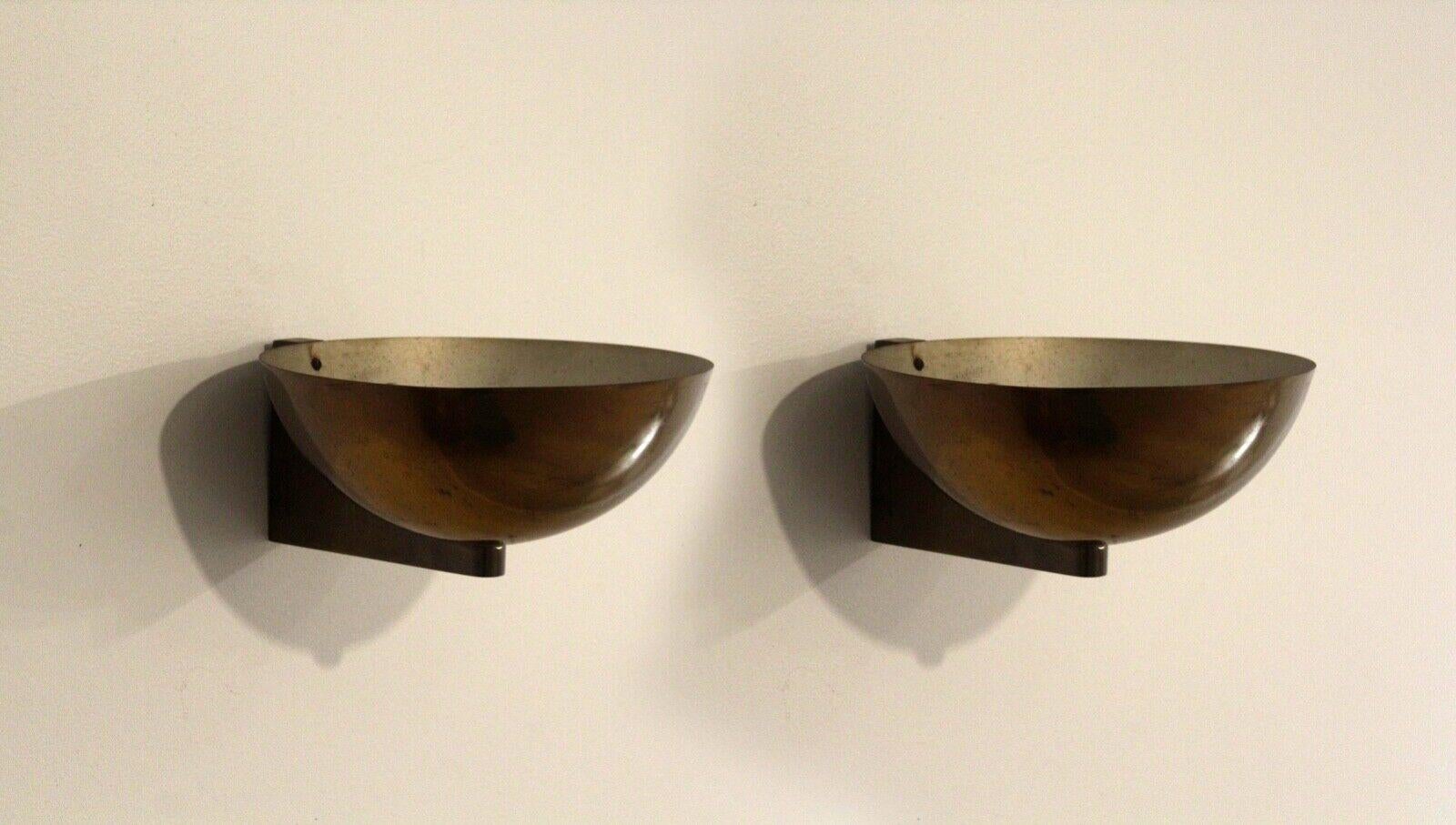 For your consideration is this vintage pair of Art Deco Machine Age streamlined brass sconces by Kurt Versen. Dimensions: 10.75w x 10d x 4.75h
 