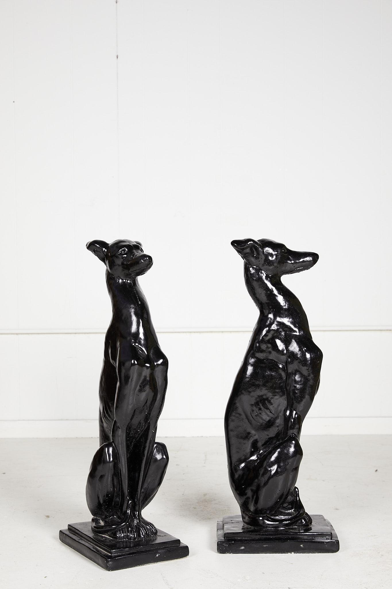 Iconic pair of vintage Art Deco style whippet statues in the seated position, cast and coated in a black gloss finish.