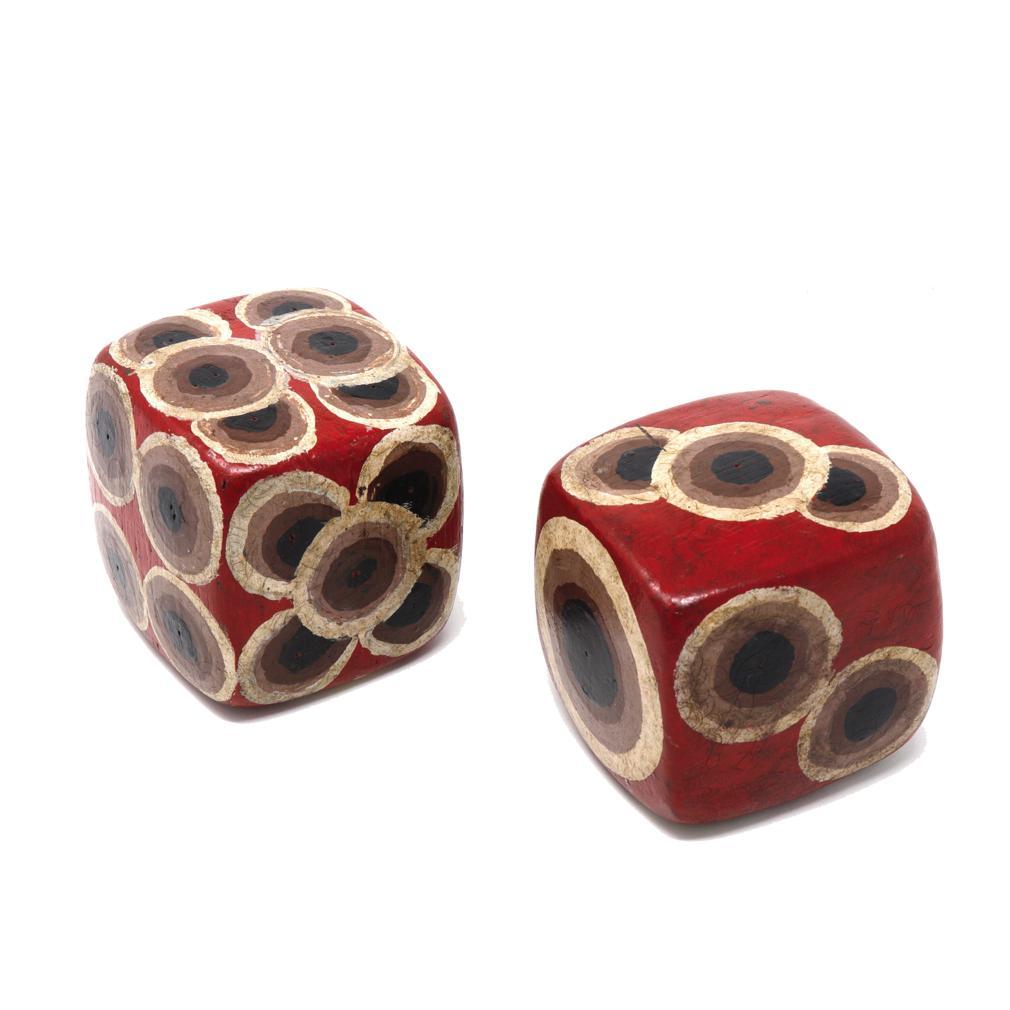 Vintage Balinese Pair of Dice. The large carved wood pair of rounded cube die called Dadu in Bahasa Indonesian were used in a traditional street game of gambling wherein bets were taken on what numbers would appear once rolled in a bucket. This pair