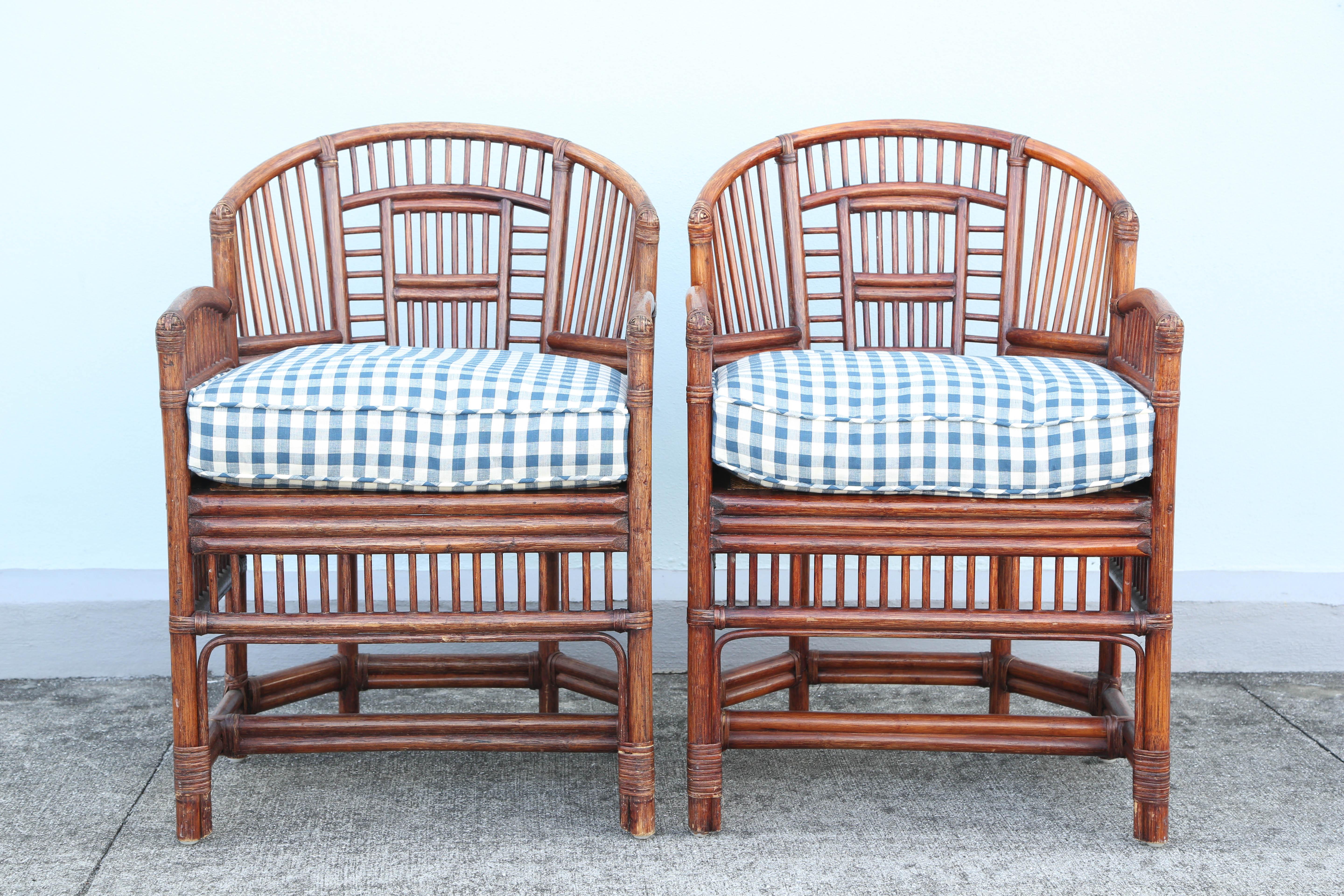 Pair of bamboo Brighton armchairs with cane seats and blue/white seat cushions.