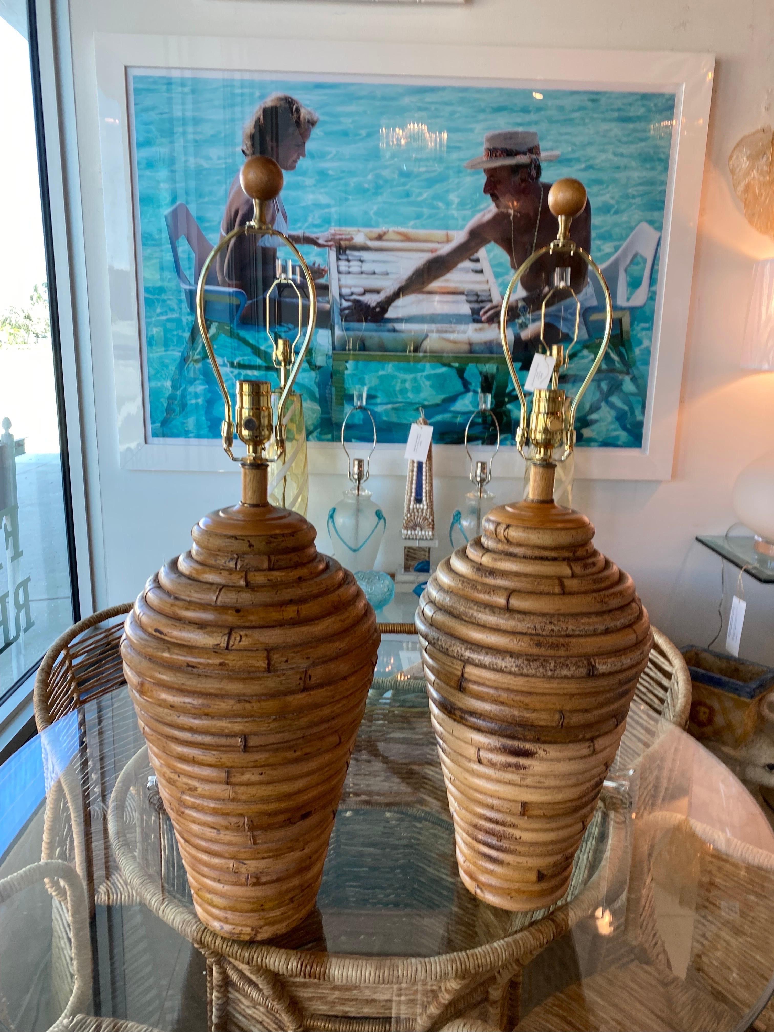 Lovely pair of vintage bamboo table lamps. These have been newly wired and have all new brass hardware with 3 way sockets. Dimensions 22 tall to socket, 30 tall to top of finial x 10 D.
