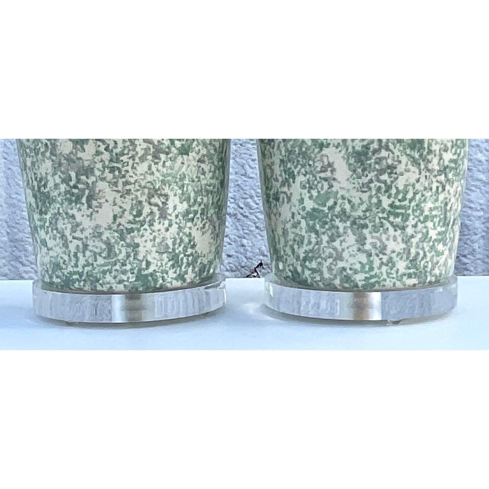 Fantastic pair of original Bauer lamps. Marked and dated 1986. Glazed ceramic urns with a mottled grey / green motif. Brass hardware. Acquired from a Palm Beach estate.