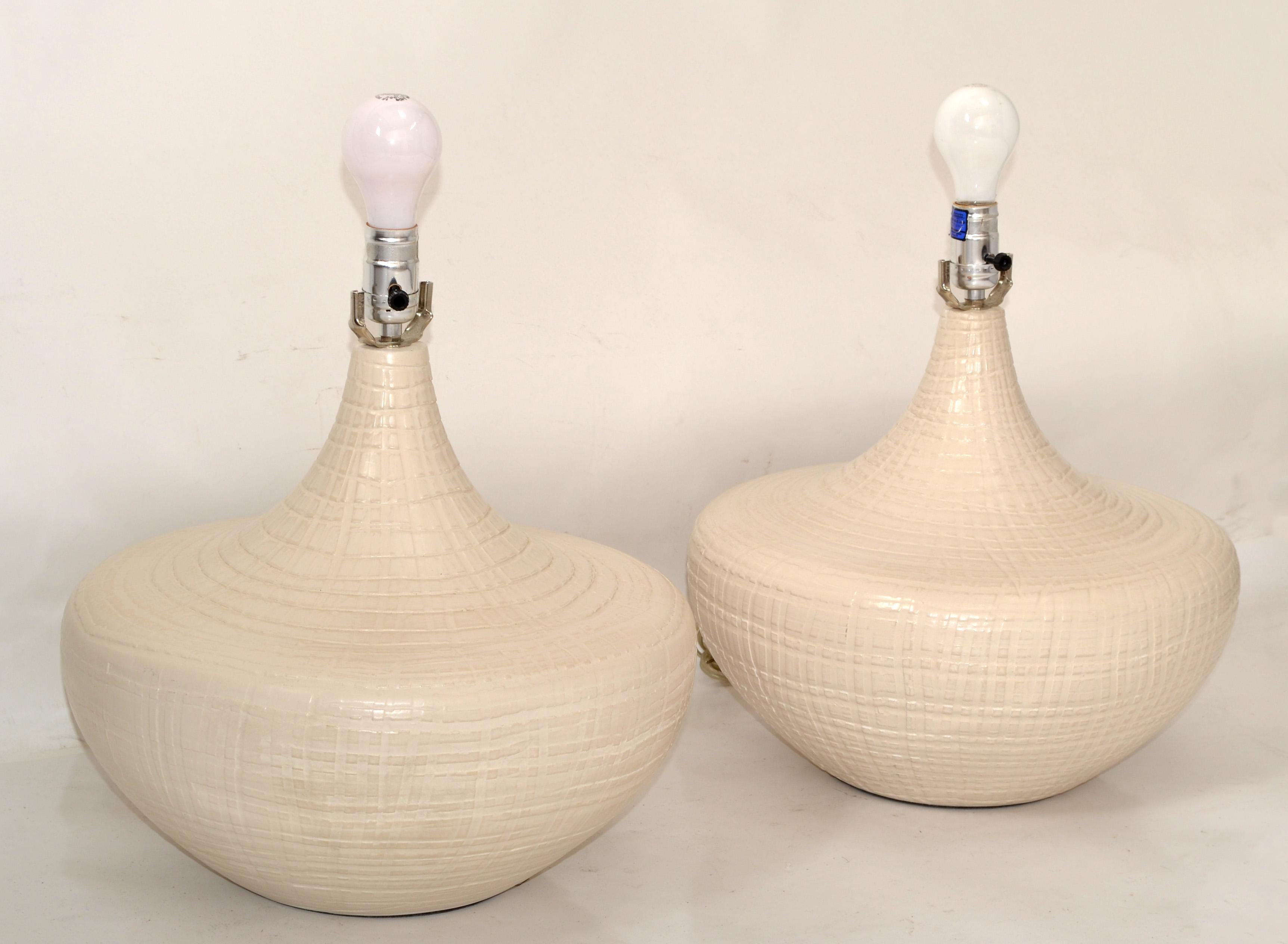 Mid-Century Modern Pair of Beige deeply incised vintage ceramic Table Lamps in a round large scale with lacquer finish.
UL Listed, each Lamp takes a regular or LED Light bulb.
No Harp, Finial, Shade.
Great Lamps for the Master Bedroom, on Top of the
