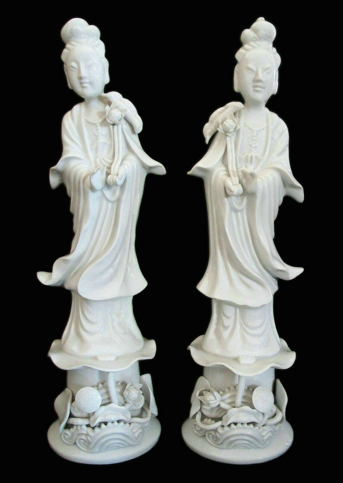 Fine vintage pair of 'Blanc de Chine' porcelain Guanyin statues - each figure holding an applied flower and standing on a lotus leaf and decorative stand - old importers foil label to the inside of each base (Montreal, Canada) - unsigned - China -