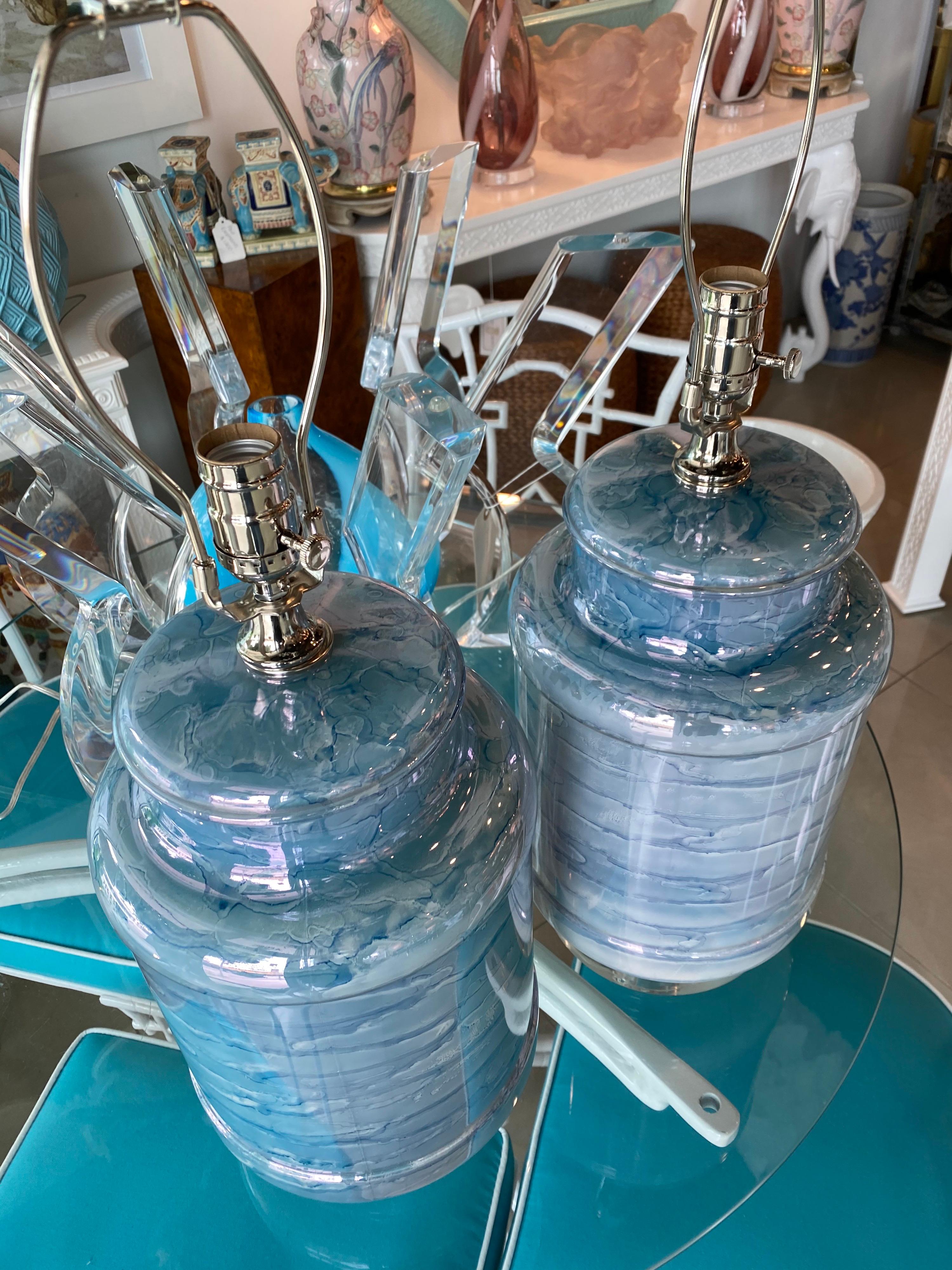 Such a pretty pair of vintage beach blue glass table lamps. Newly wired with all new chrome hardware, 3 way sockets. Chunky lucite base and matching finials. Measures: 19 H to top of socket, 26 H to top of finials.