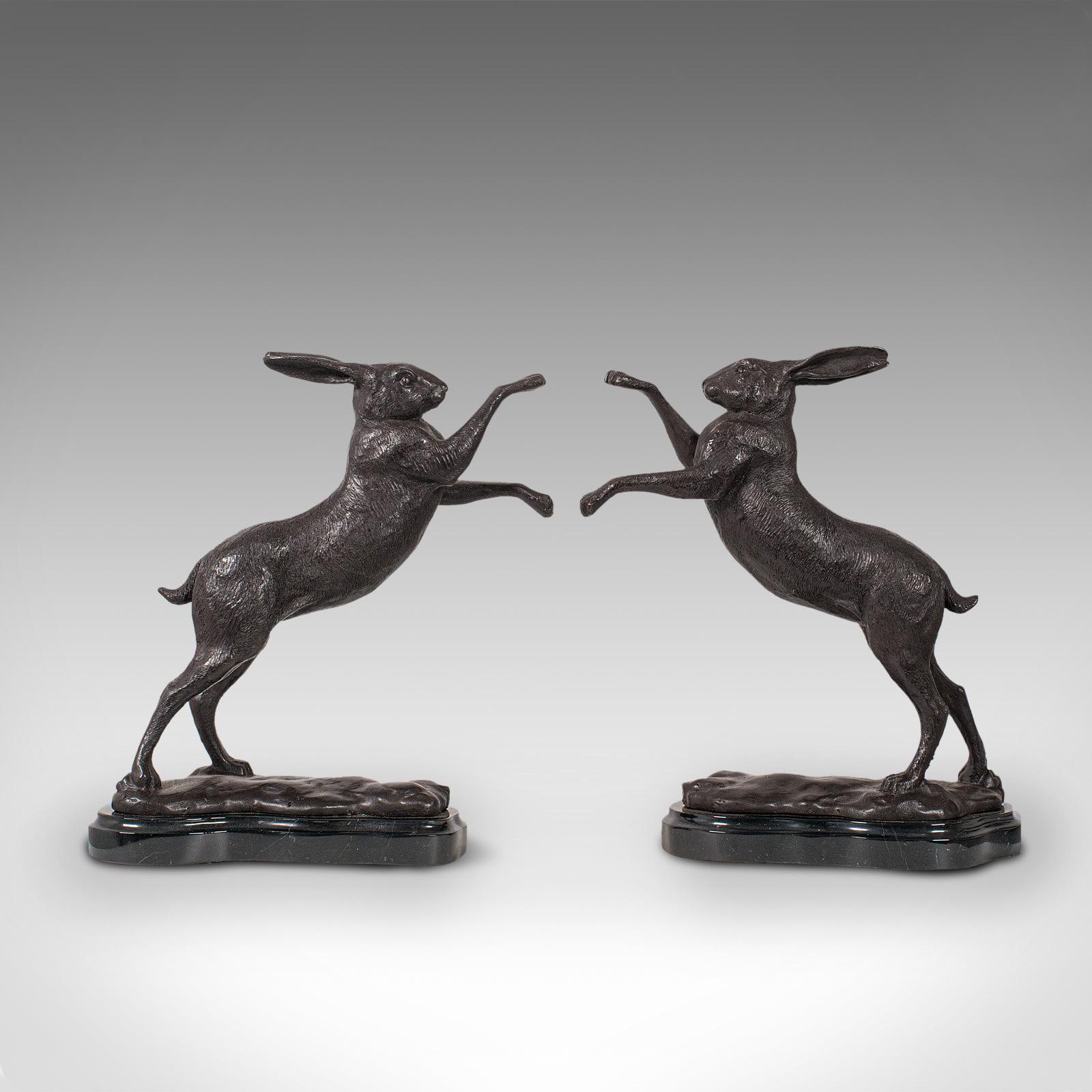 This is a vintage pair of boxing hares. An English, bronze figure of natural interest, ideal as bookends and presented upon marble bases, dating to the mid-20th century, circa 1960.

Choose your corner as the two pugilists ready to go fur and