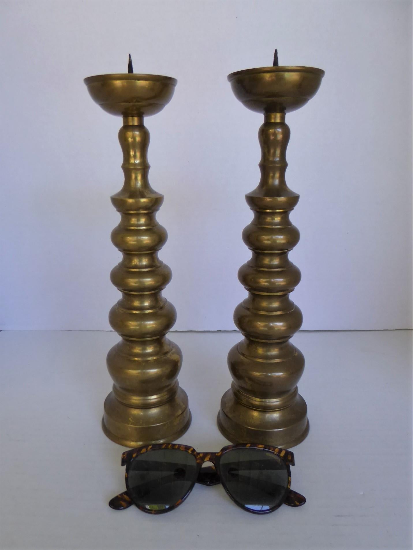 Probably from the 1960s, Brass Candle Prickets inspired by the altar candleholders used on shrines throughout Asia. Workmanship is very good in the manufacturing of the items, thus possibly made in Hong Kong.  Simple and modern design of decreasing