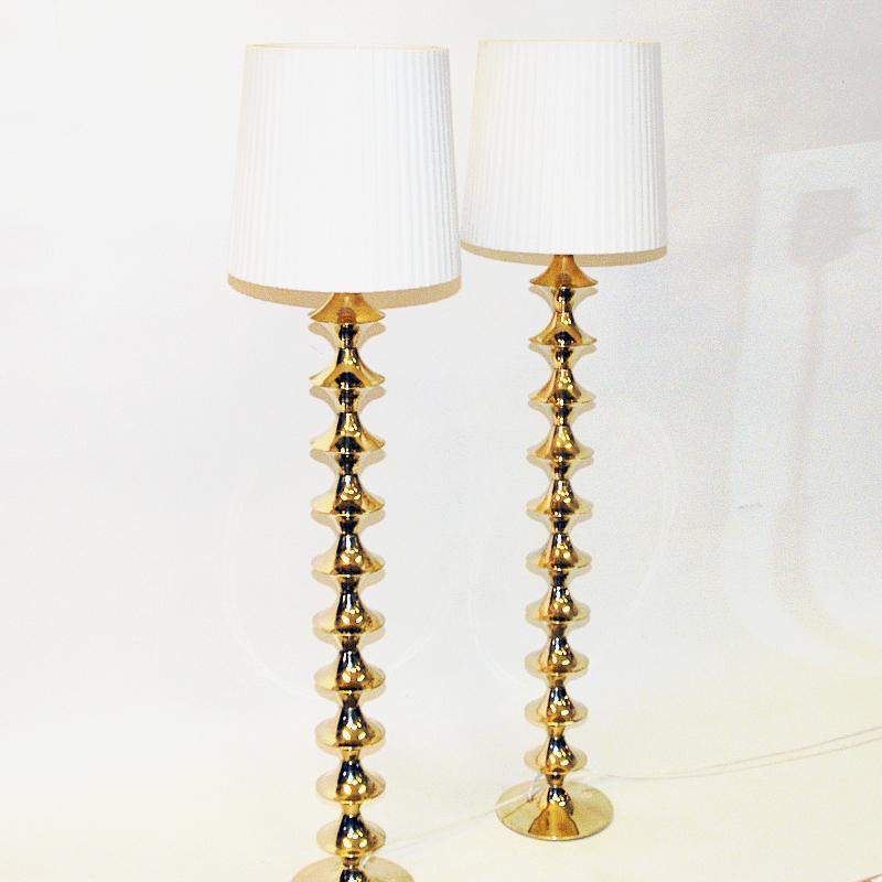 Perfect pair of brass floor lamps from Elit AB - Sweden 1960s. Classic midcentury lamps suitable as a pair or standing alone. Solid twirled designed brass pole with a round lamp base. Majestic look and in good vintage condition. Great lamps for any