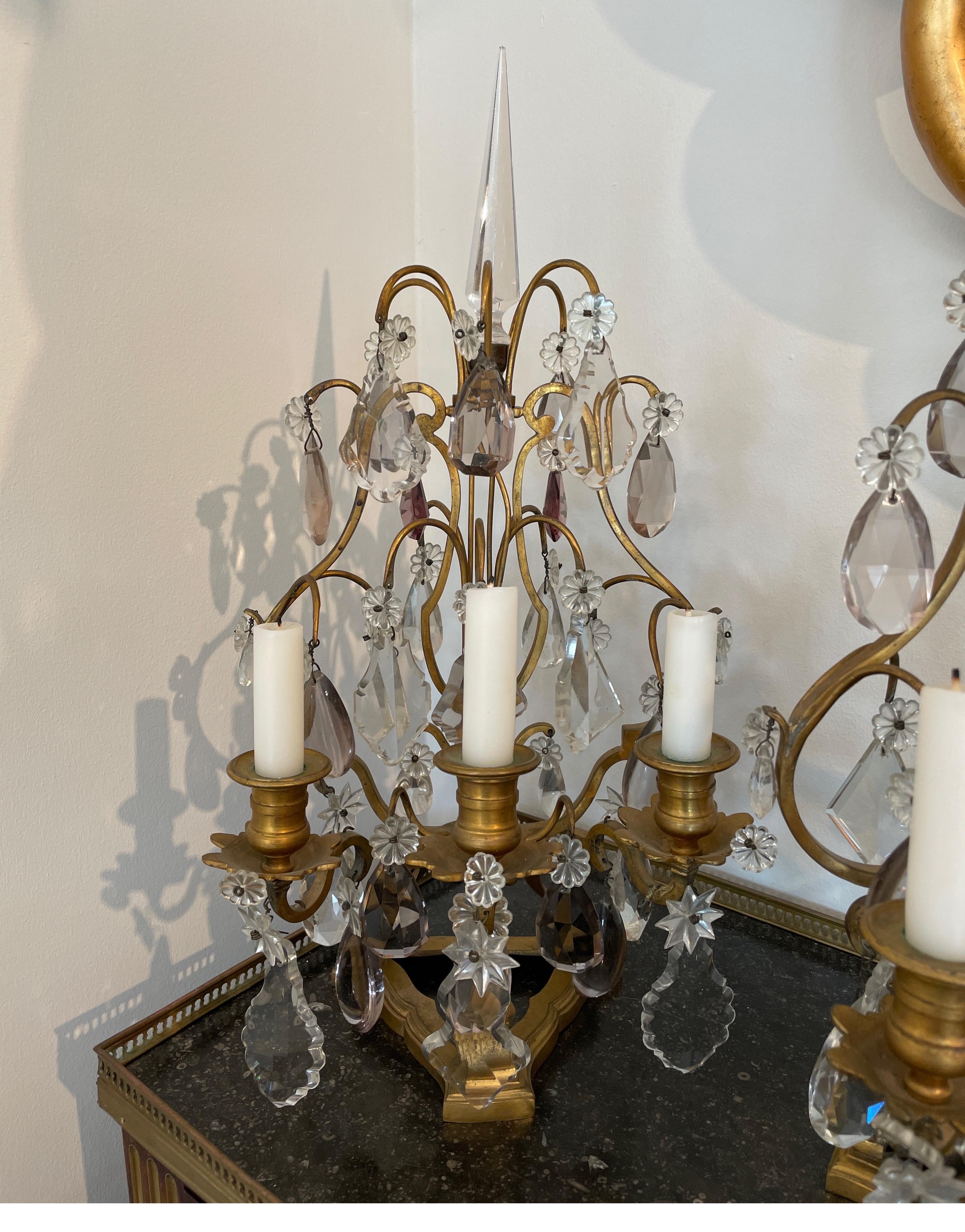 Vintage bronze & crystal girandoles with three arms for candles.