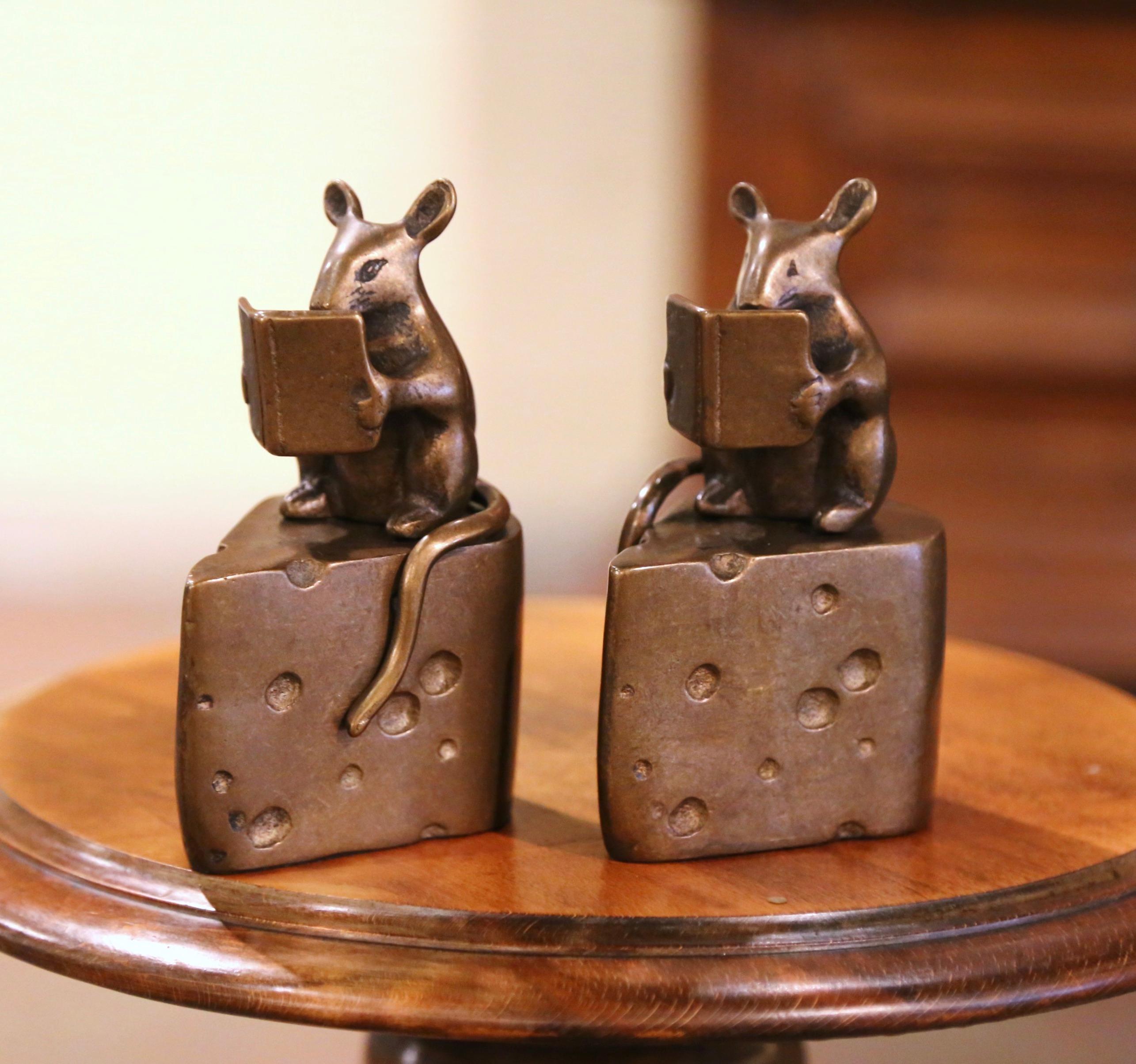Complement your space with this cheerful pair of mice sculptures. Crafted in France, circa 1970, each cast bronze figurine features a sleek and elegant design, beautifully accentuated by a rich patinated bronze finish. Resting upon cheese wedges,