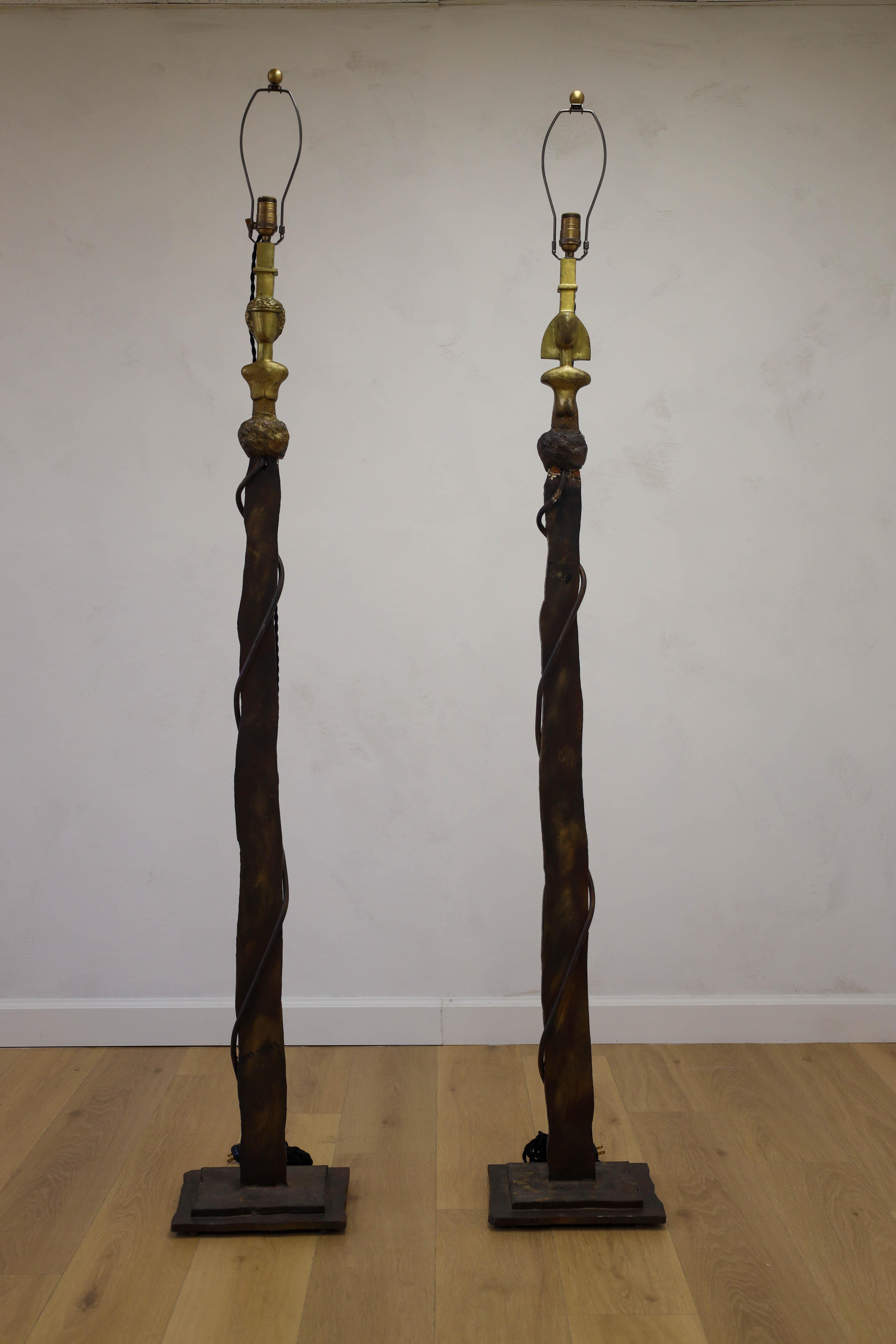 Styled after Giacometti, these one of a kind pair of floor lamps that will elevate your space with their unique design. The sculptures offer an organic curvature made from bronze metal with the female and male busts in a brass finish. A fun piece of