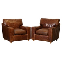 VINTAGE PAIR OF BROWN DISTRESSED LEATHER ARMCHAiRS