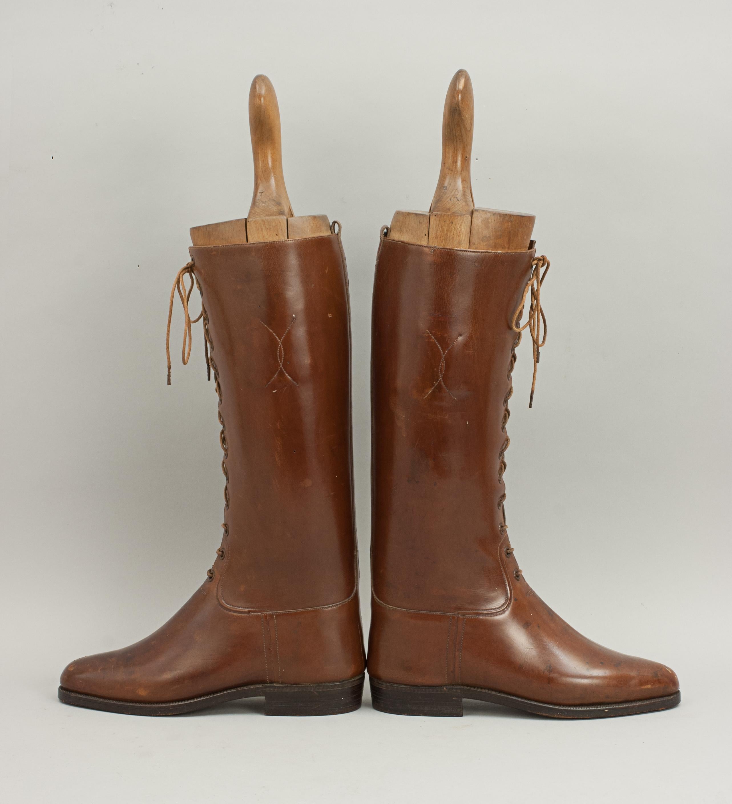 Vintage pair of brown leather ladies lace up riding boots.
A pair of mid calf tan leather front lace up women's riding boots with original beech wood trees. The leather on these boots is in very good condition, the trees have had wood worm (now