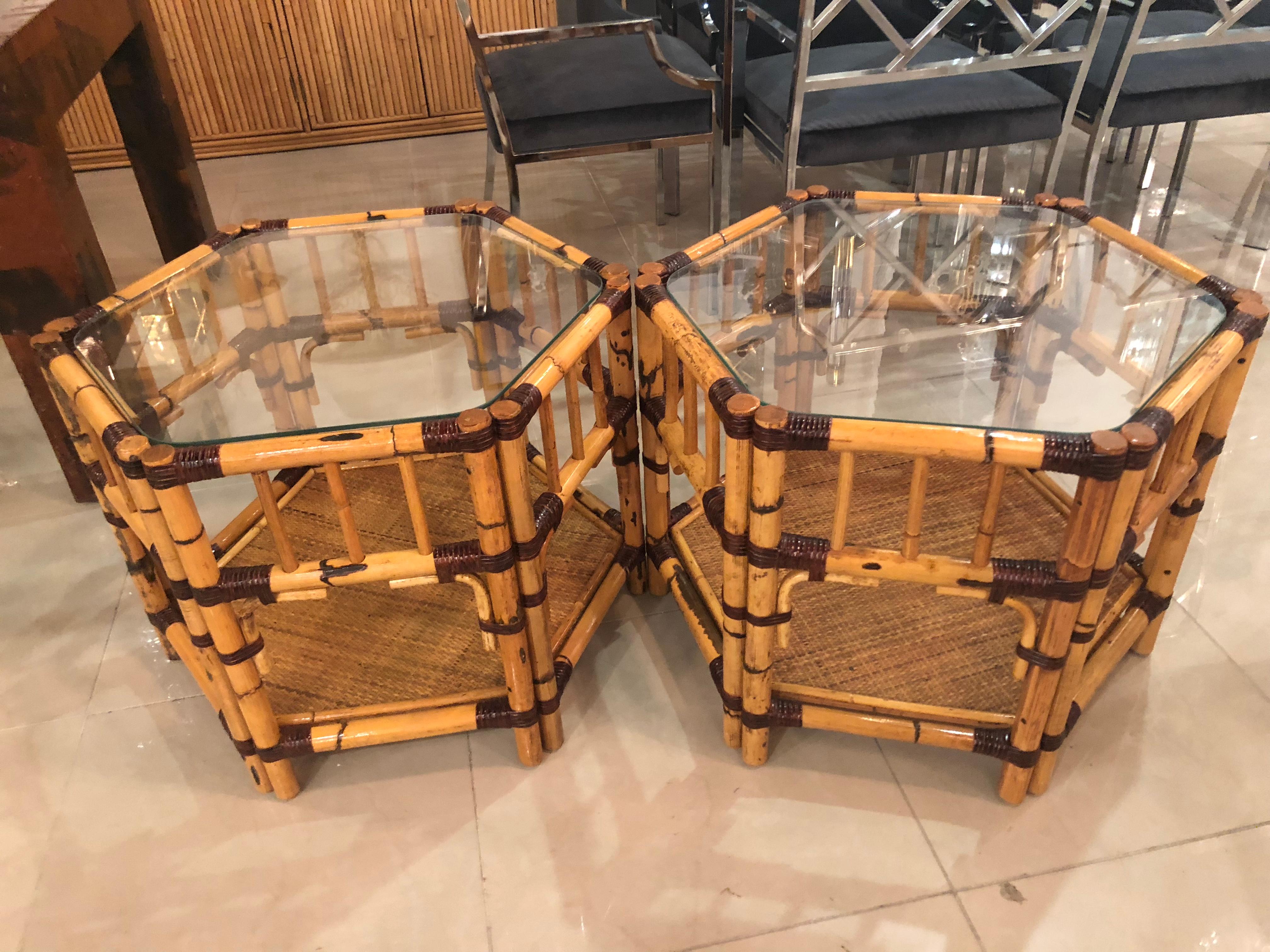 Vintage pair of burnt rattan bamboo octagonal end side tables. New glass tops were cut for the tops. The bamboo has been restored. Beautiful tables.
    