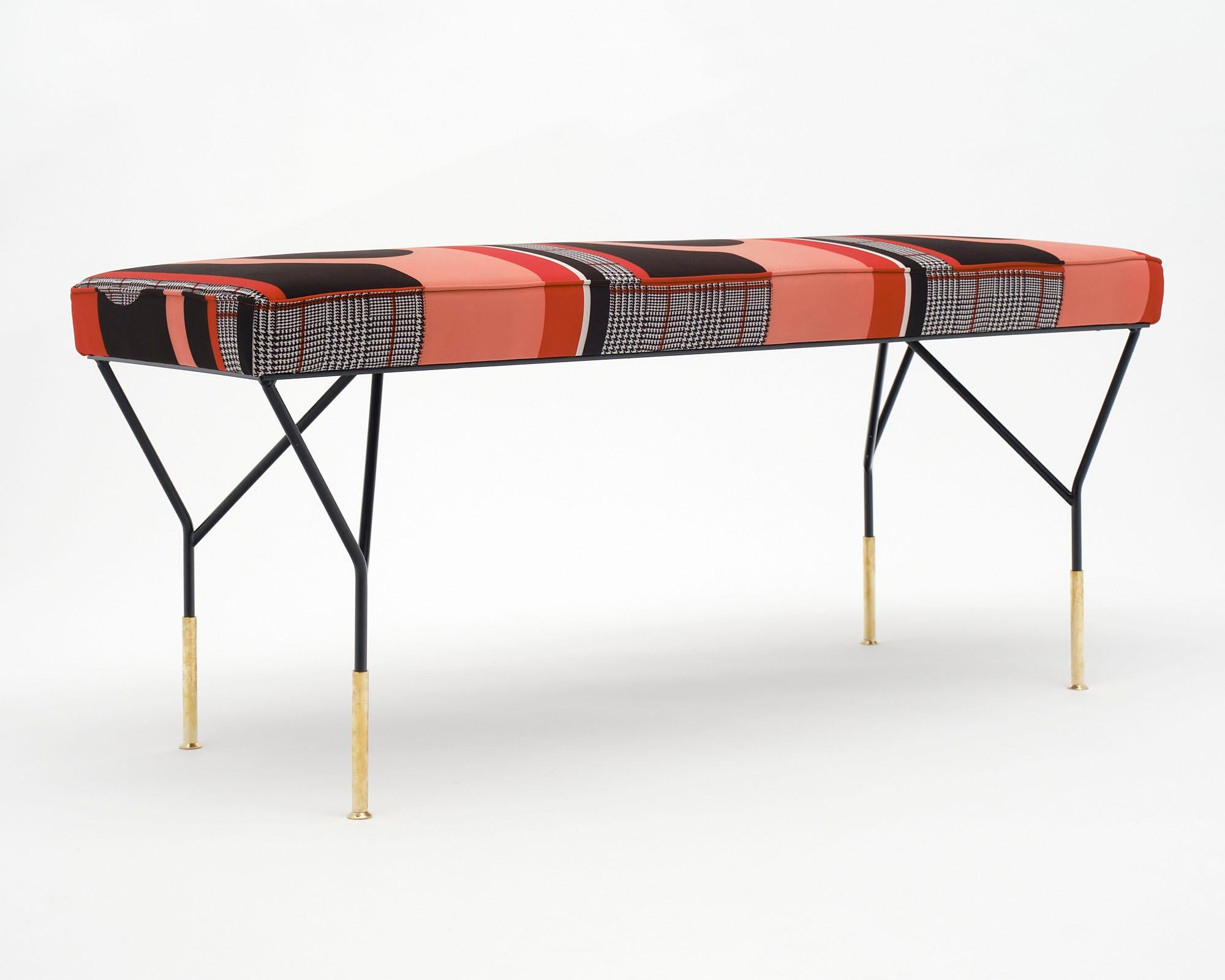 Pair of Italian benches with black lacquered steel and brass legs. New upholstery done in a custom Italian fabric.