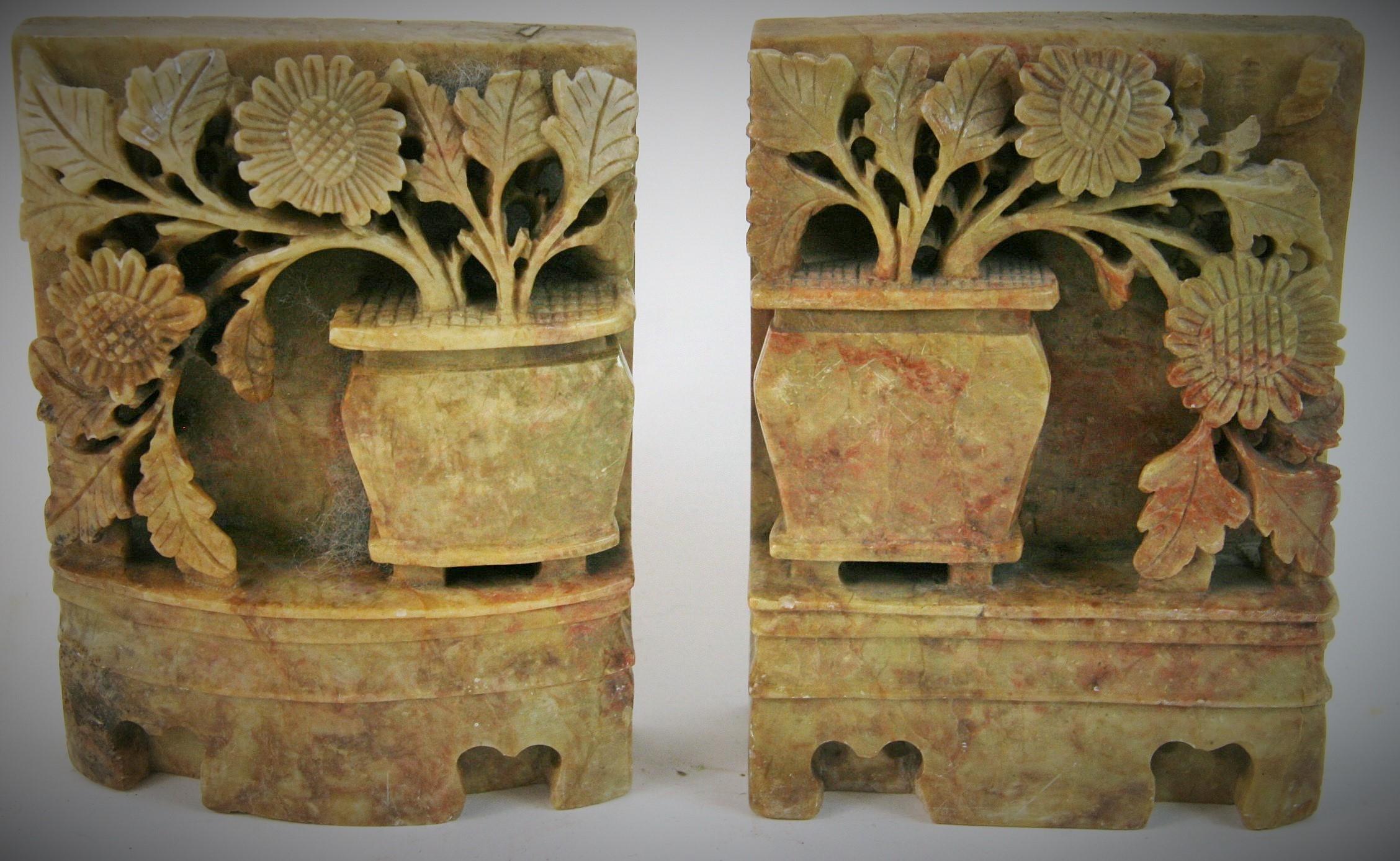 8-166, a vintage pair of Chinese bookends offering deeply carved soapstone with jardinière with draping foliage, circa 1930s.